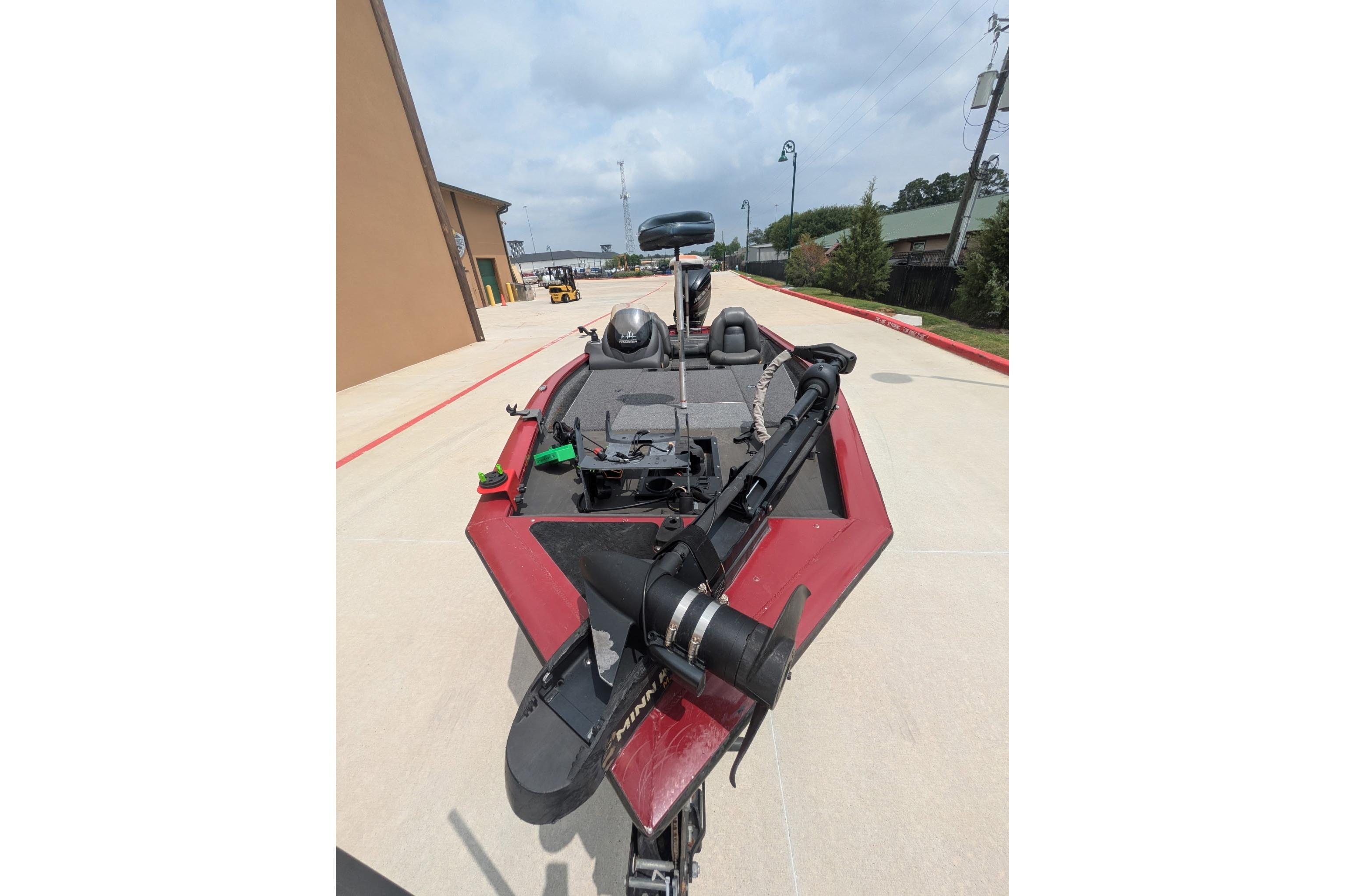 2019 Tracker Pro Team 190 boat on a concrete driveway, featuring a red exterior.