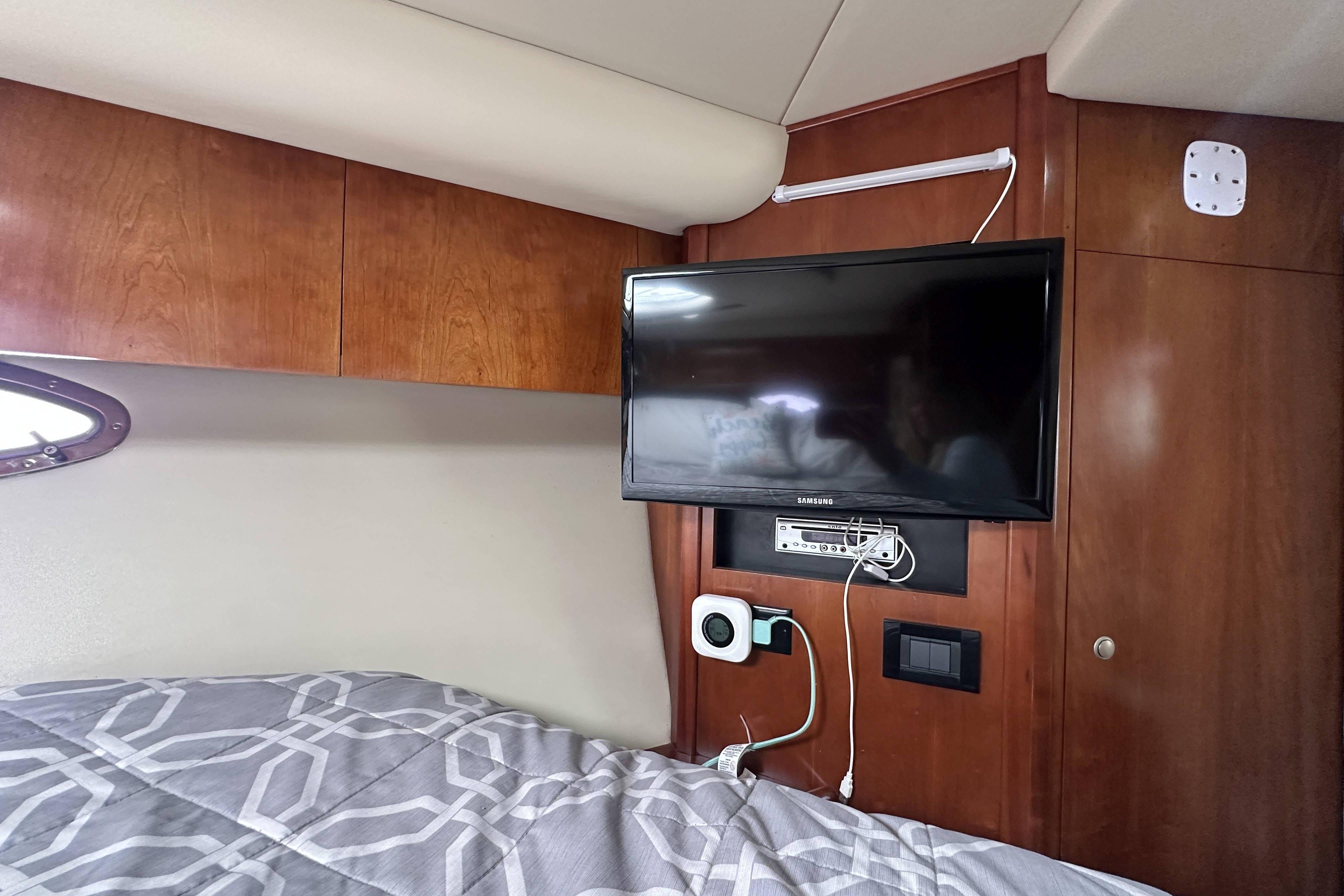 Interior of 2007 Cruisers Yachts 390 Express Coupe with TV and wooden cabinetry.
