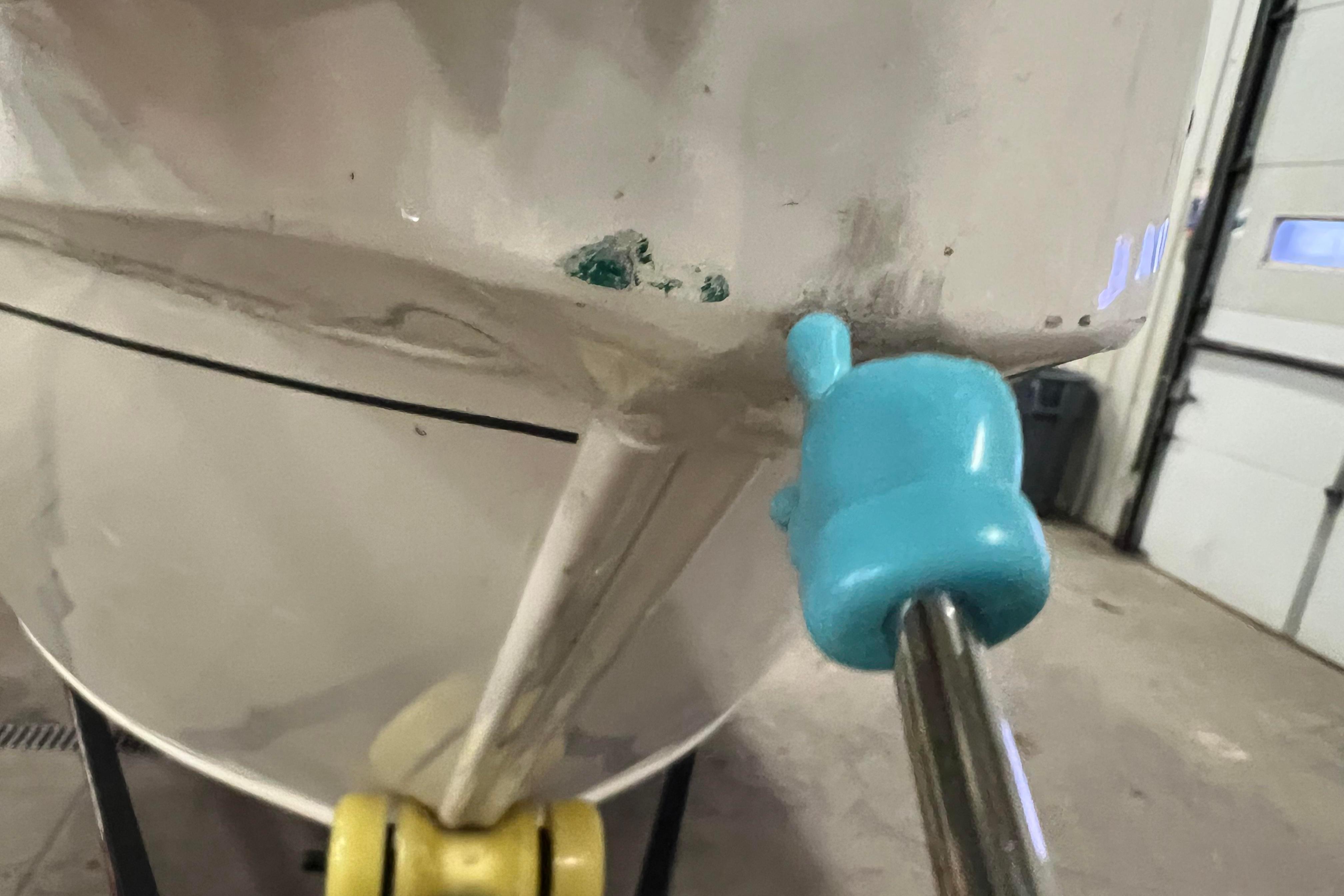 2022 Tracker Pro Guide V-16 WT boat hull with visible damage and repair tool.