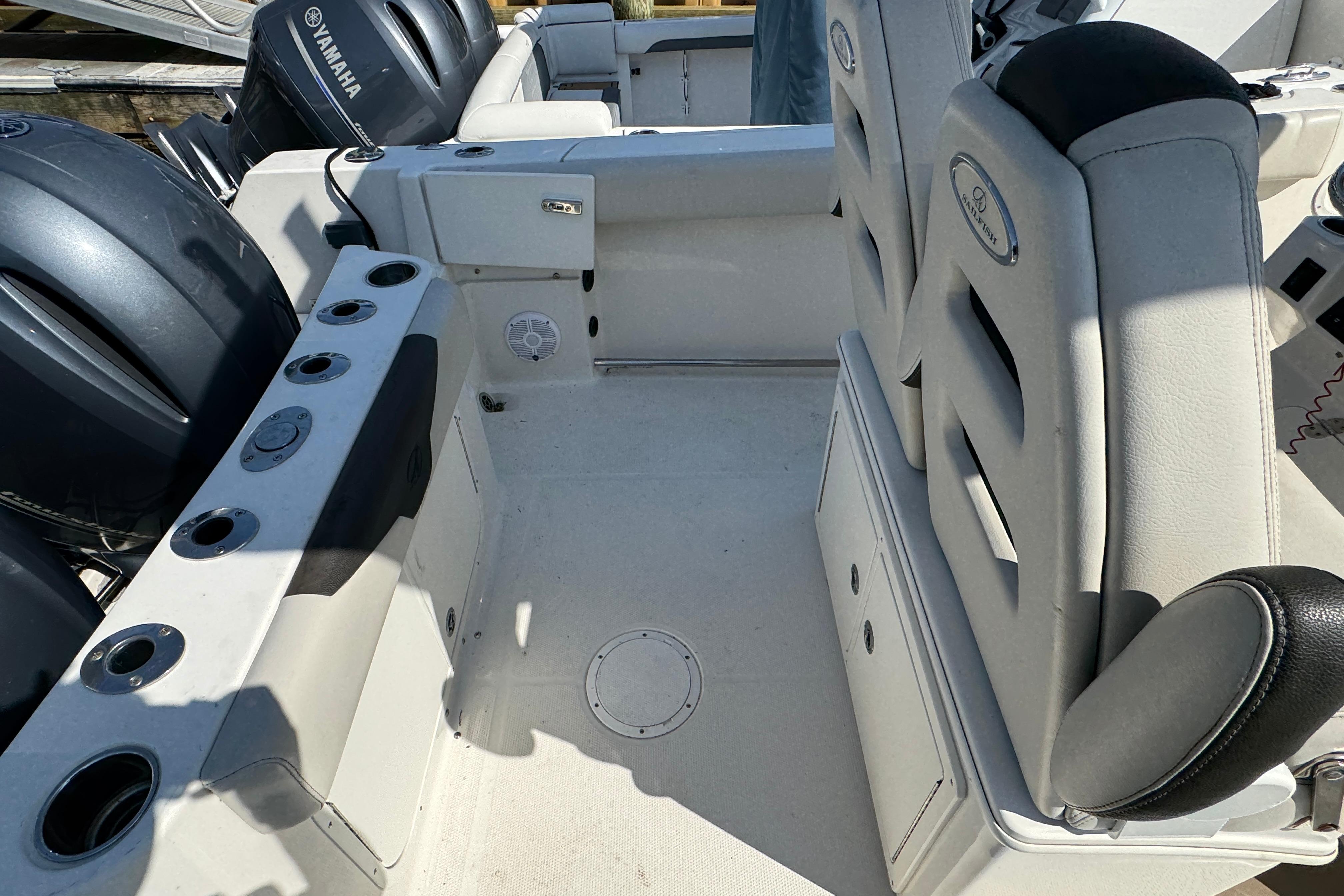 2022 Sailfish 242 CC boat interior with Yamaha engines and seating area.