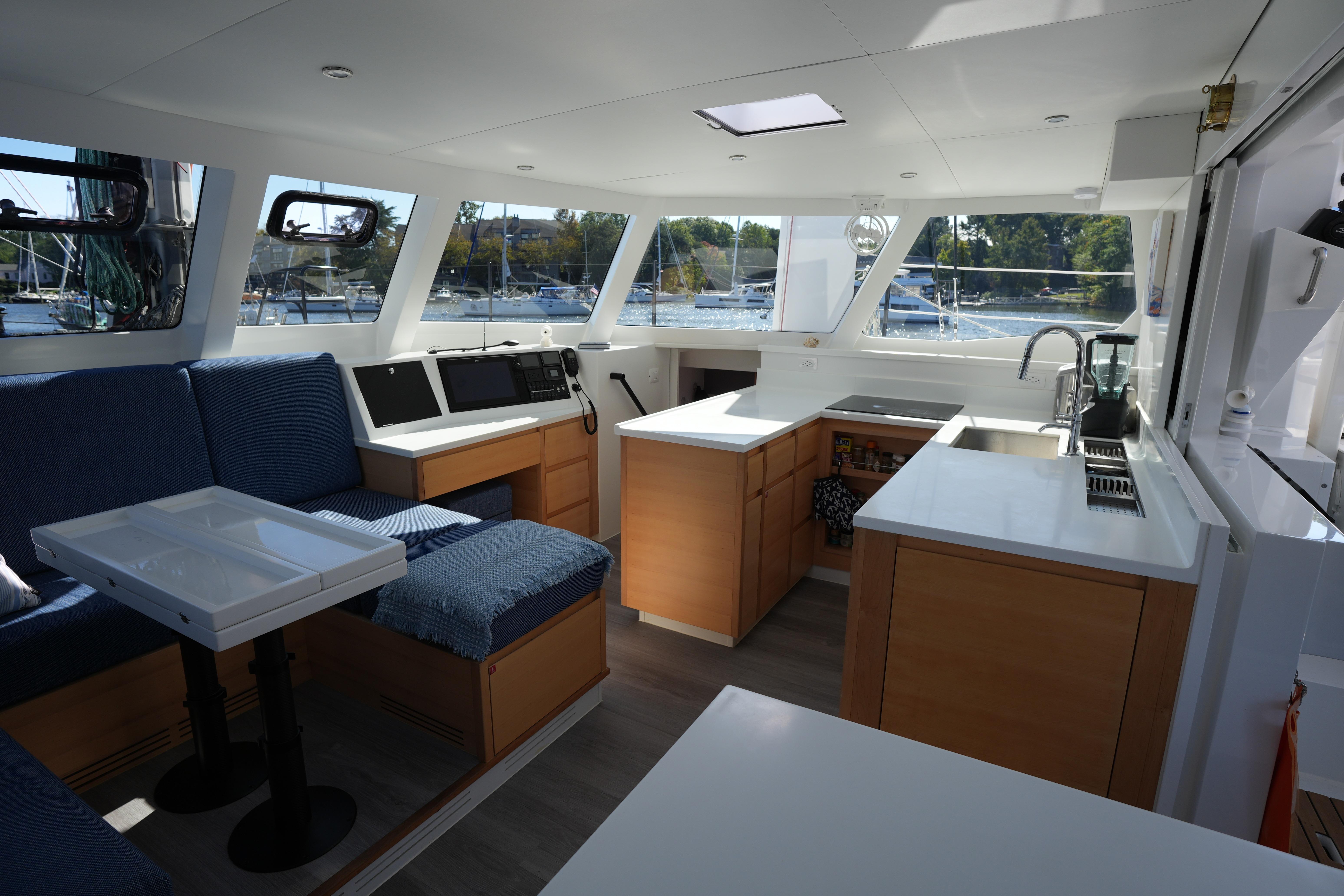 Modern interior of 2024 Balance 442 yacht with spacious seating and kitchen area.