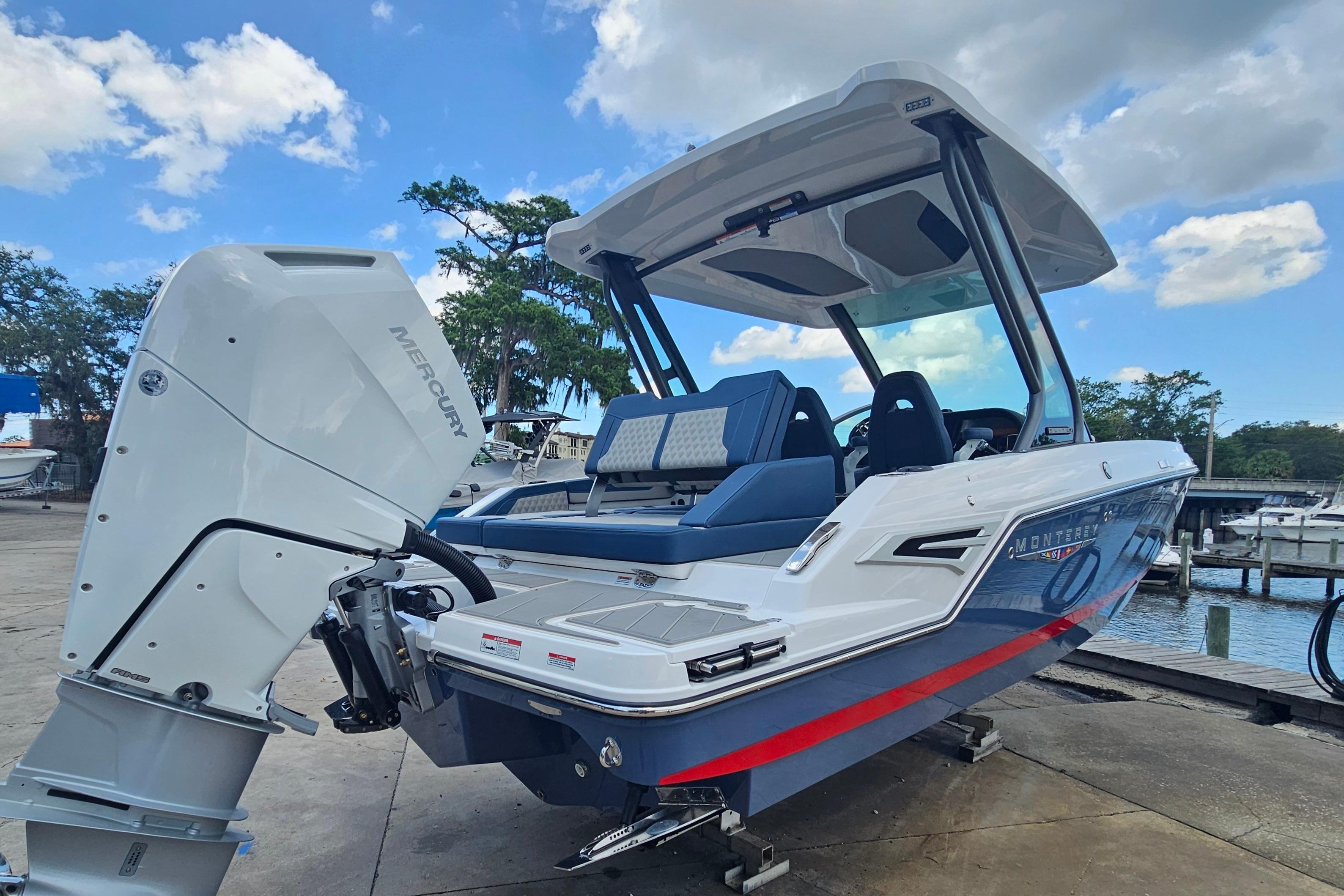 2026 Monterey Elite 27 OB boat with Mercury outboard engine at dockside.