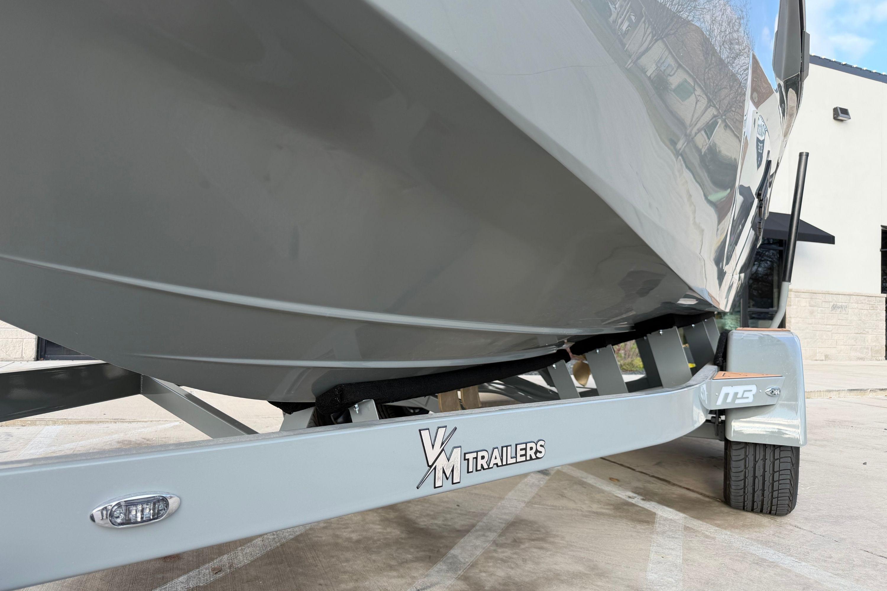 2026 MB B52 21 Alpha boat on VM trailer, parked outdoors.