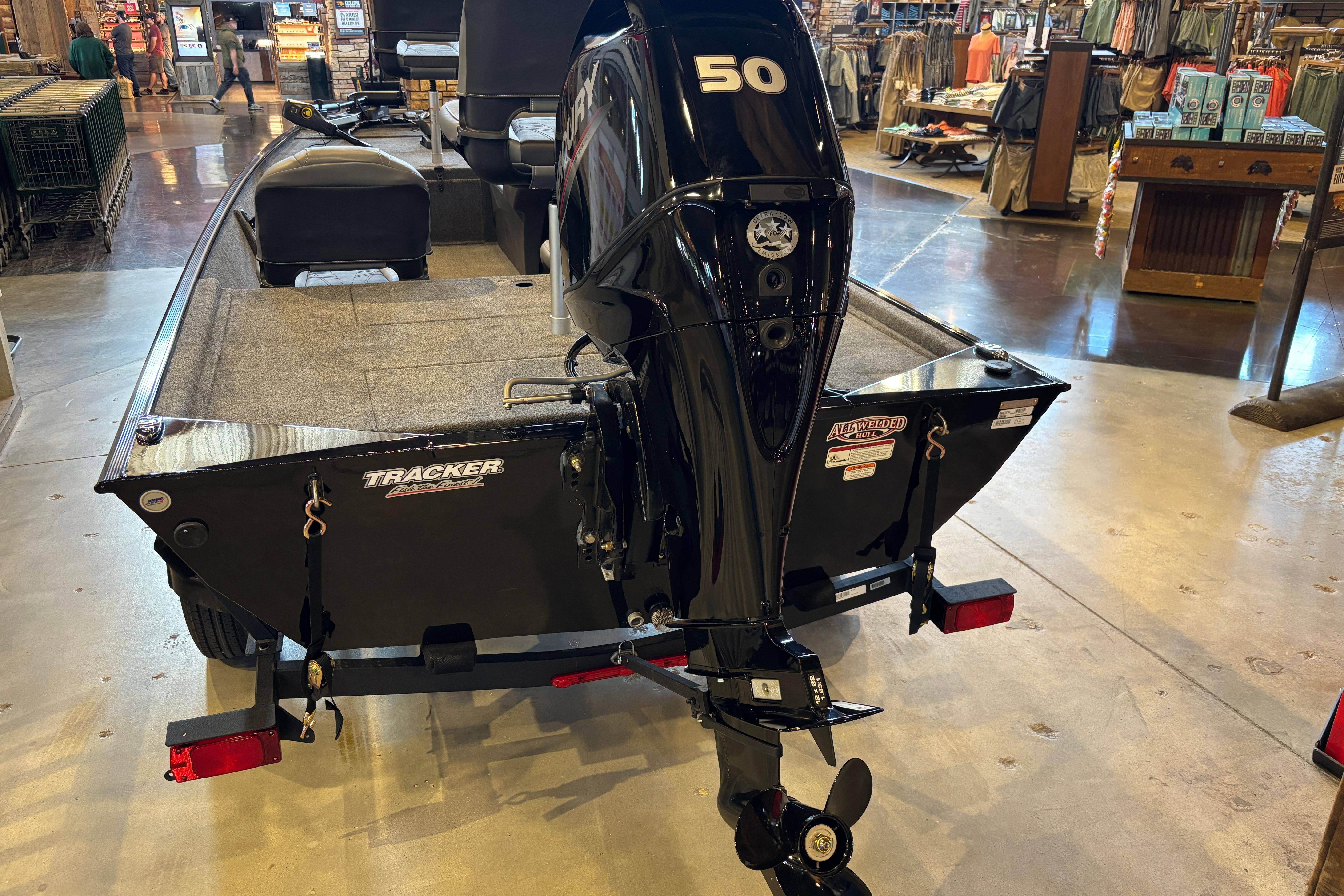2026 Tracker Bass Tracker Classic XL boat with 50 HP motor displayed indoors.