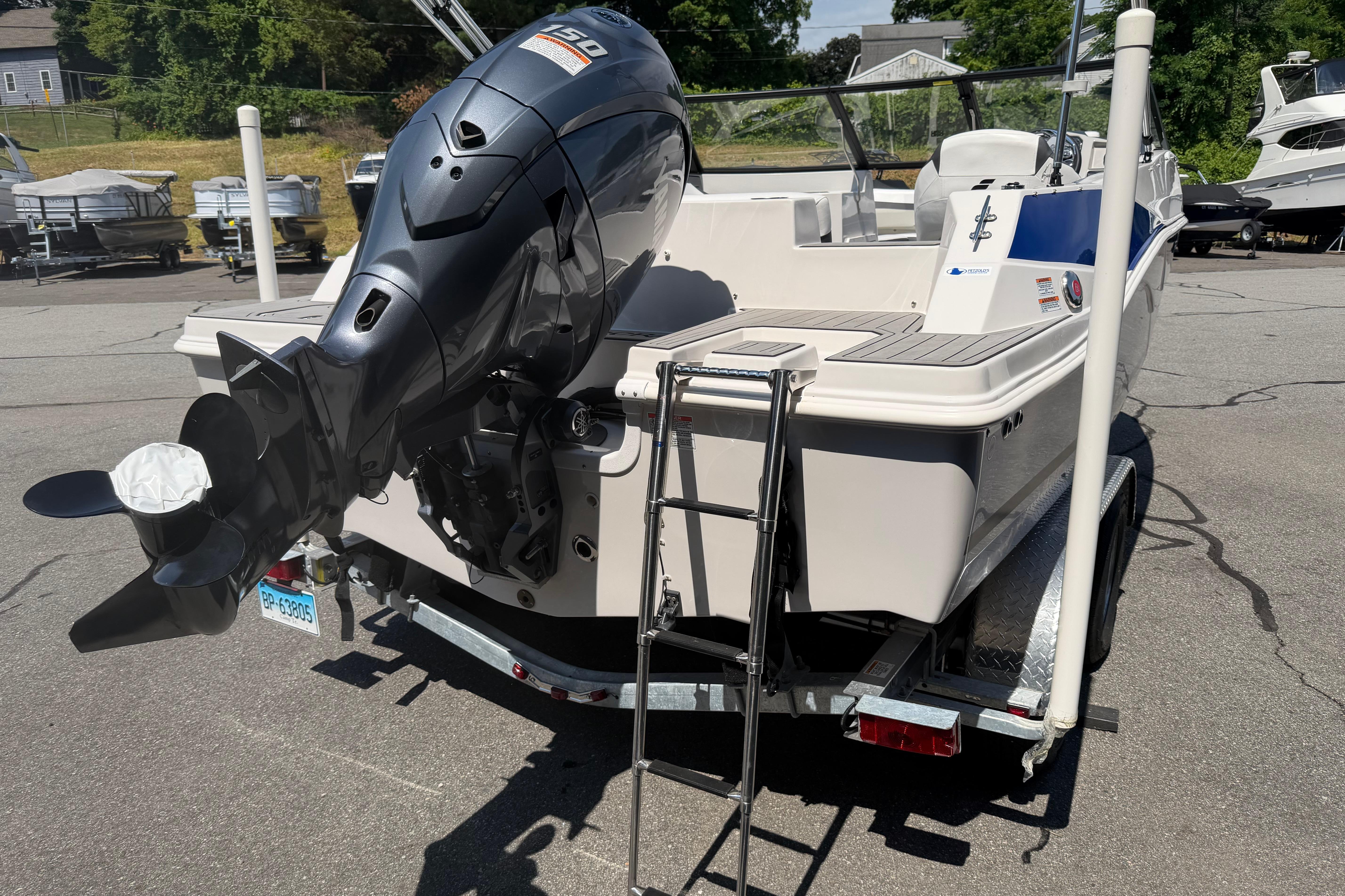2025 Starcraft SVX 190 OB boat with outboard motor and trailer in a parking lot.