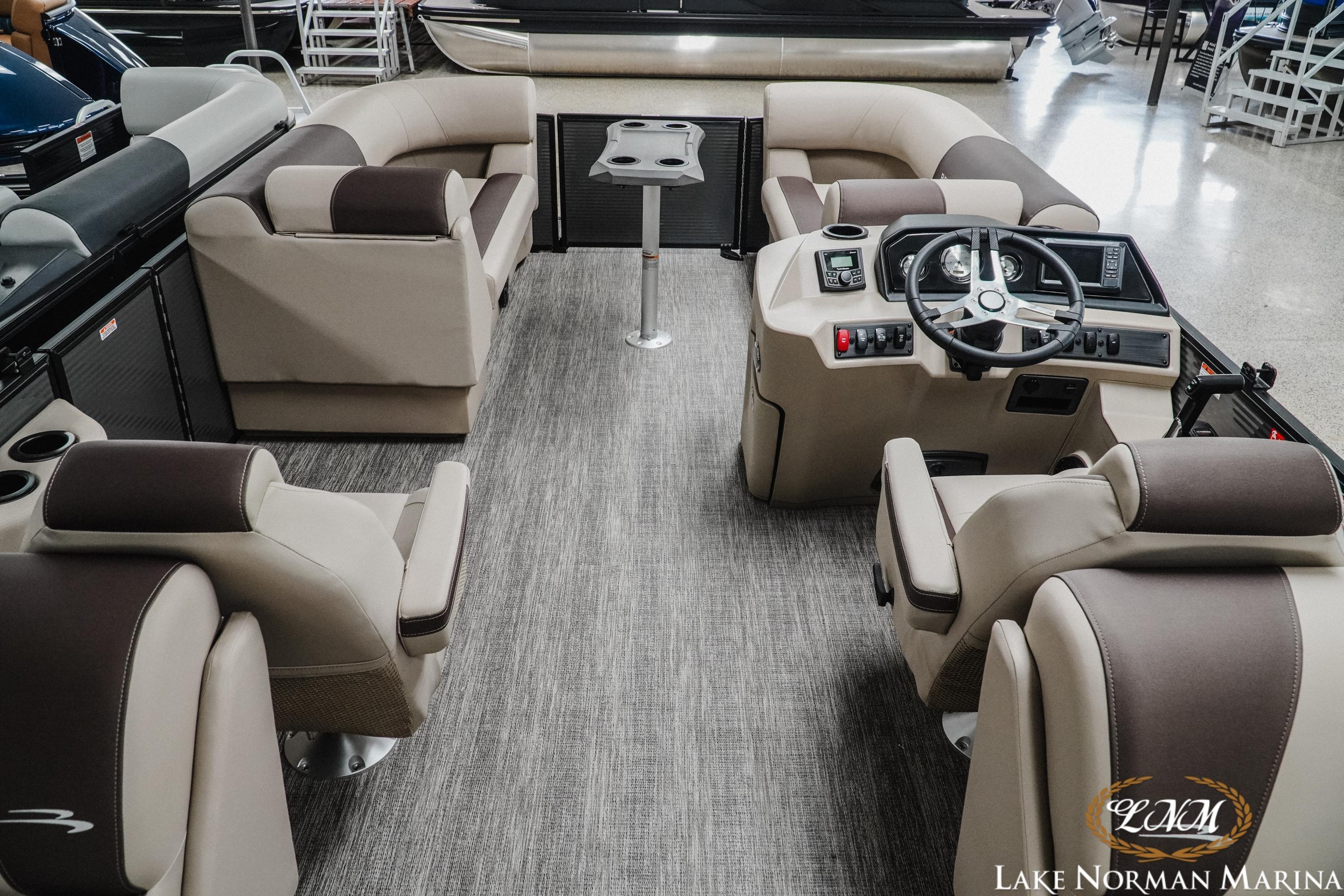 Luxurious interior of 2026 Bennington 22SSR pontoon boat with plush seating and modern helm.
