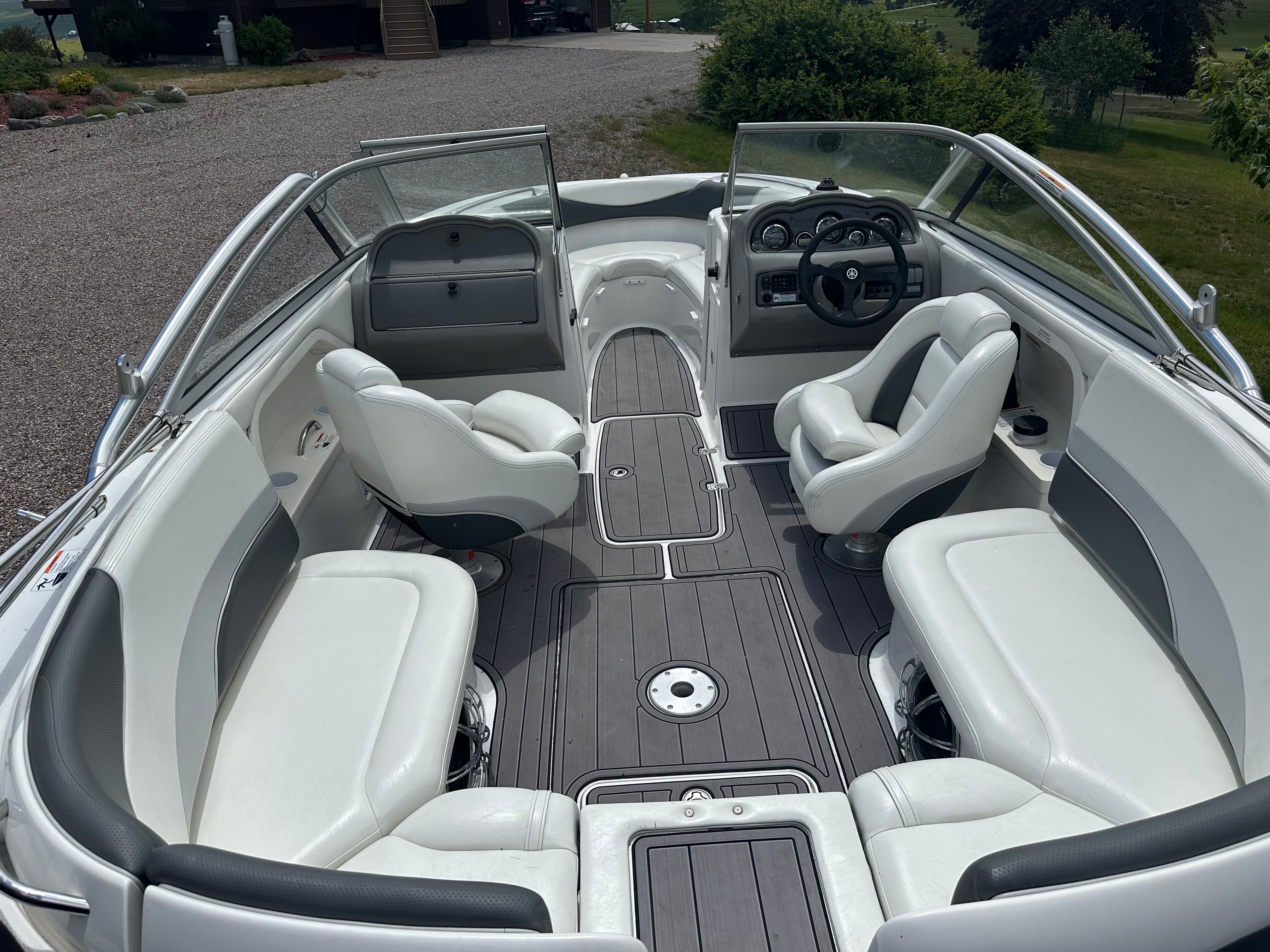 Interior of a 2005 Yamaha AR230 HO boat with white seating.