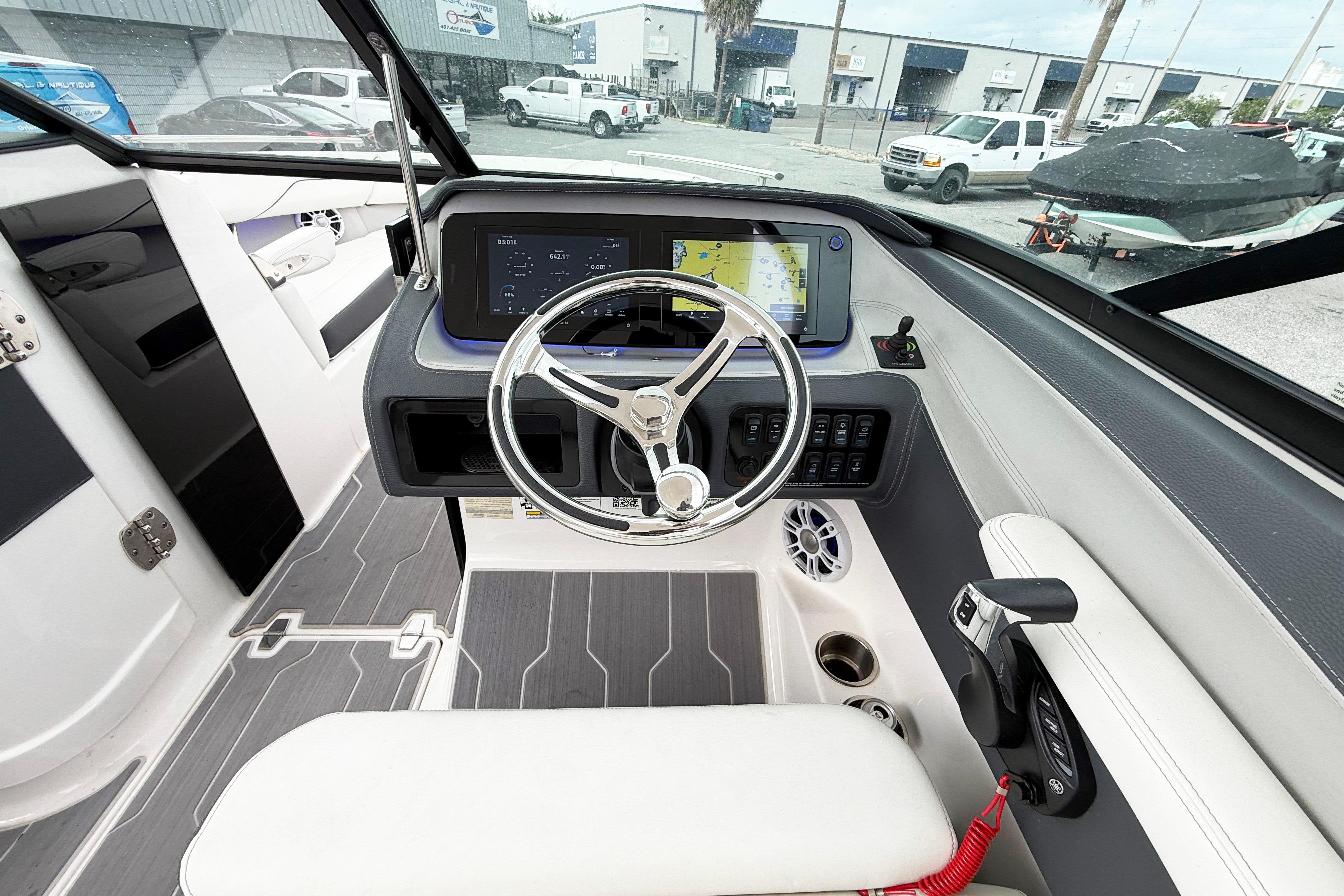 2024 Regal LX4 boat cockpit with modern steering, touchscreen display, and control panel.