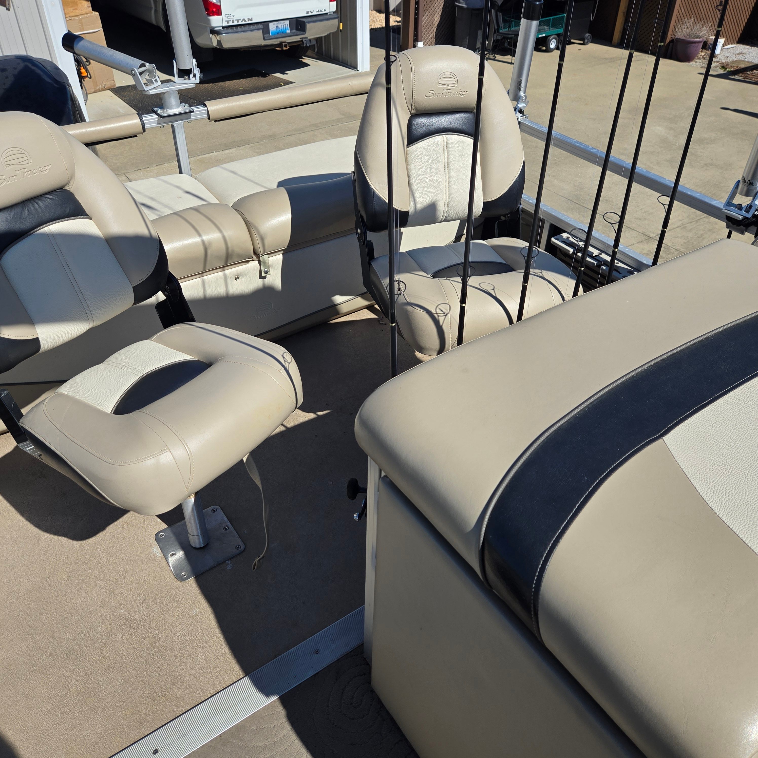 Interior of a Sun Tracker Fishin' Barge 24 DLX with beige and black seating.