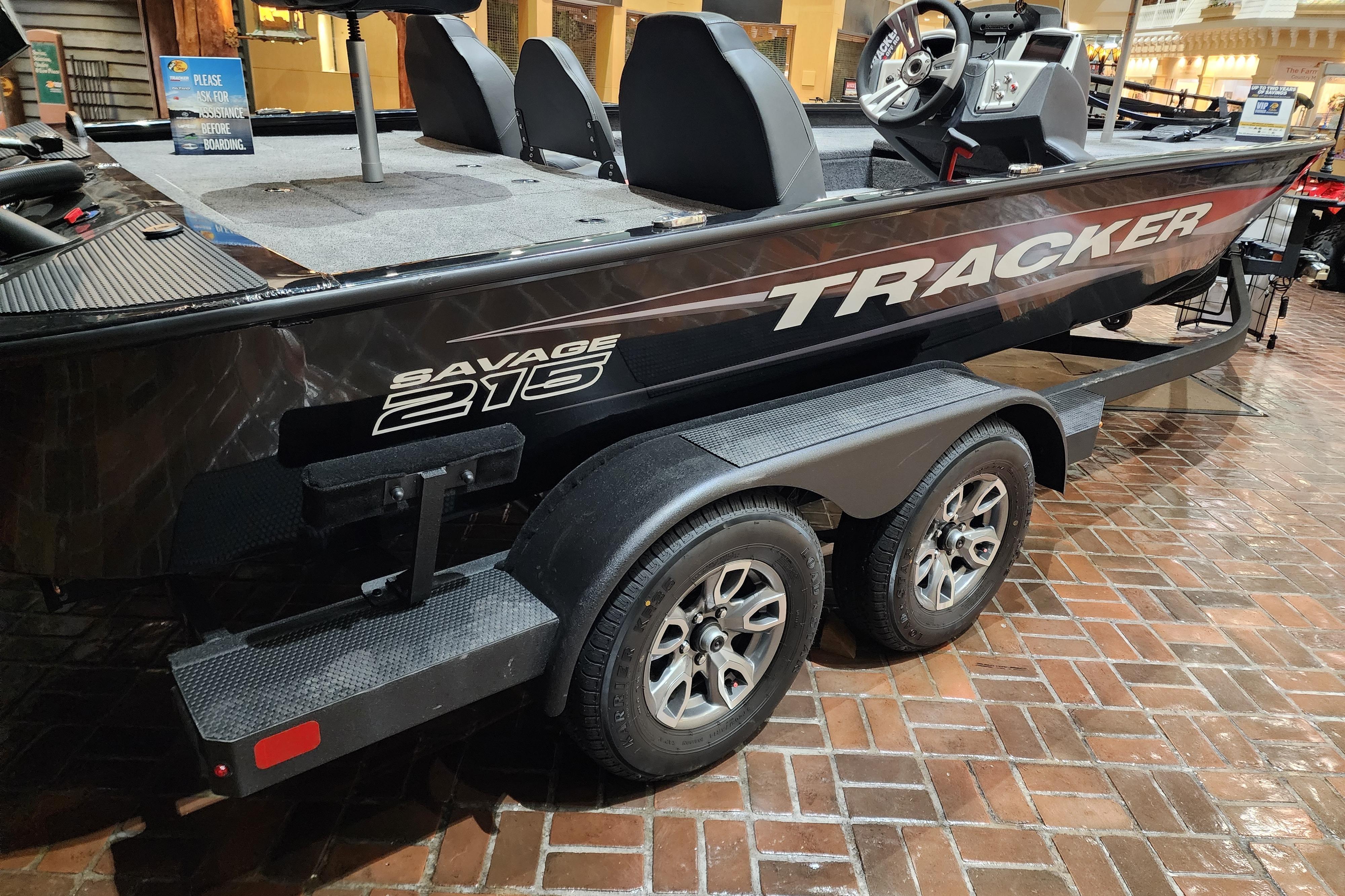2025 Tracker Savage 215 boat on display, featuring sleek design and dual-axle trailer.
