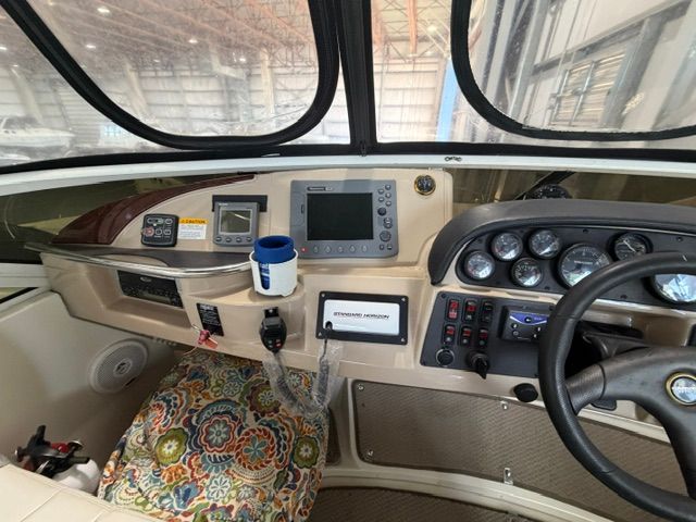 The cockpit of a 2005 Carver 44 Cockpit Motor Yacht with instruments and a steering wheel.