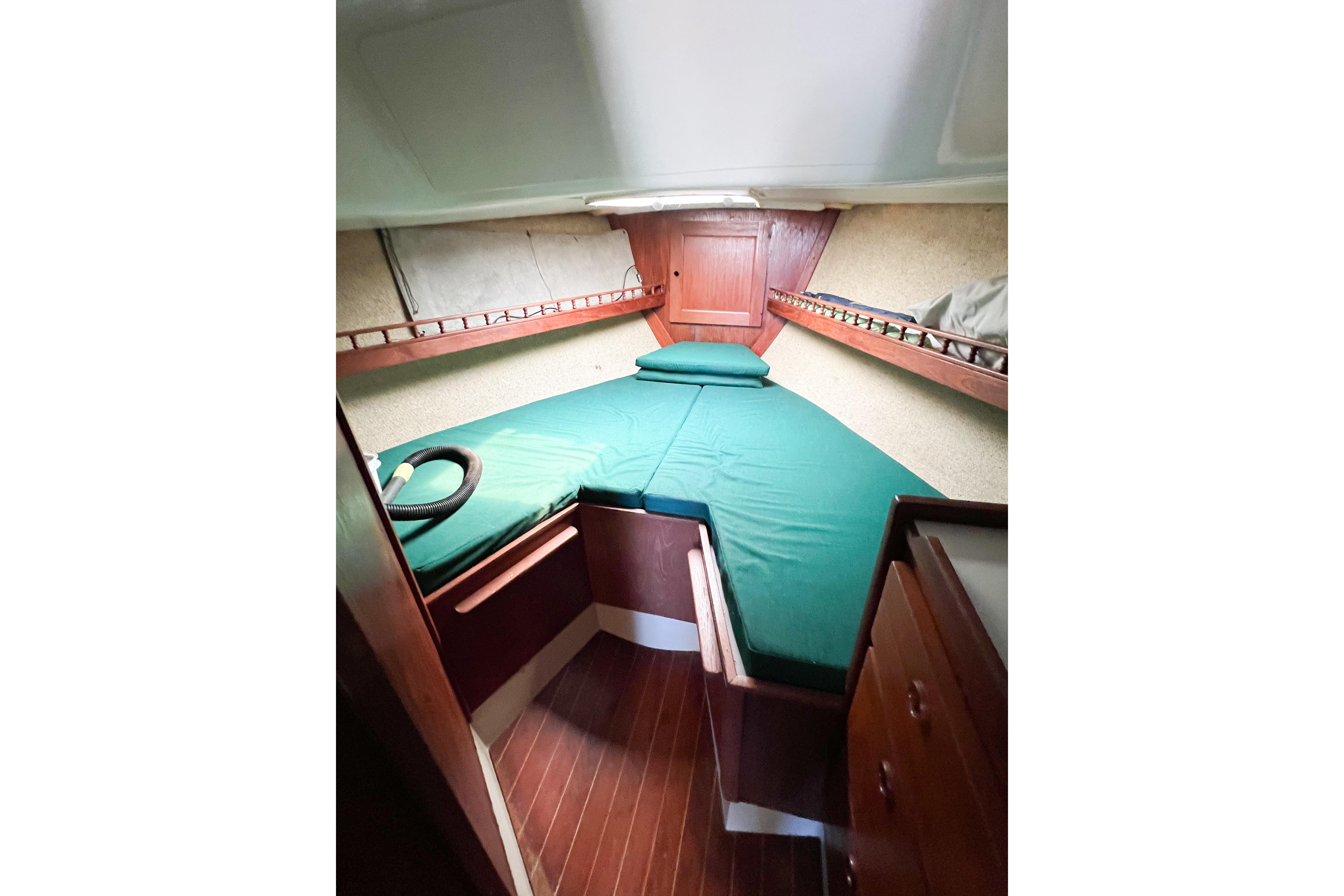1978 CAL 34 sailboat cabin with green bedding and wooden interior.