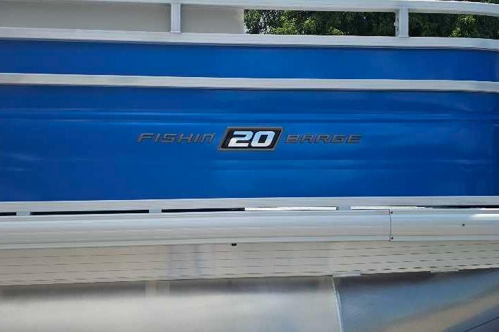 2026 Sun Tracker Fishin' Barge 20 DLX, blue exterior detail with logo.