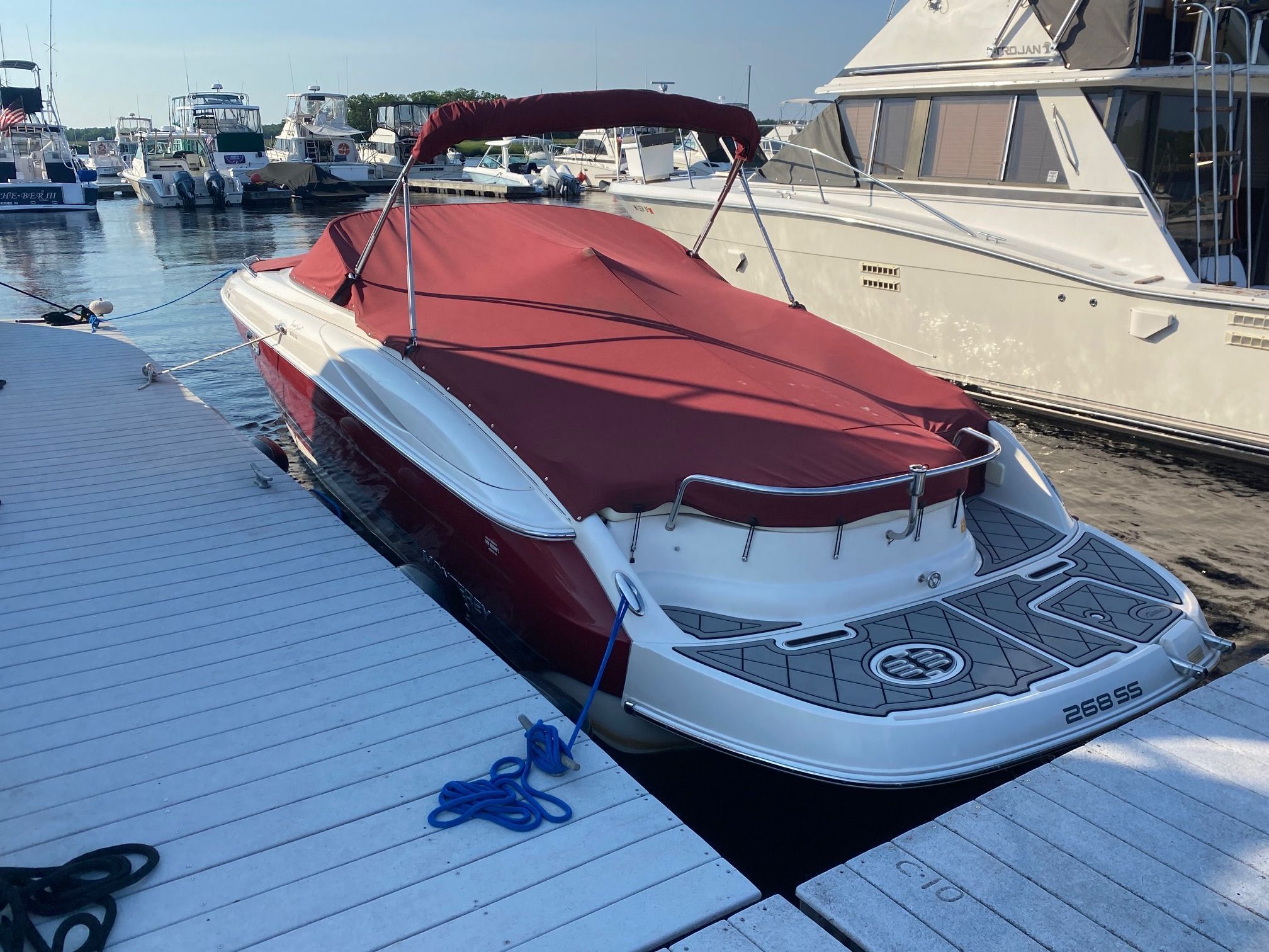 A 2006 Monterey 268SS Super Sport docked, featuring a red cover.