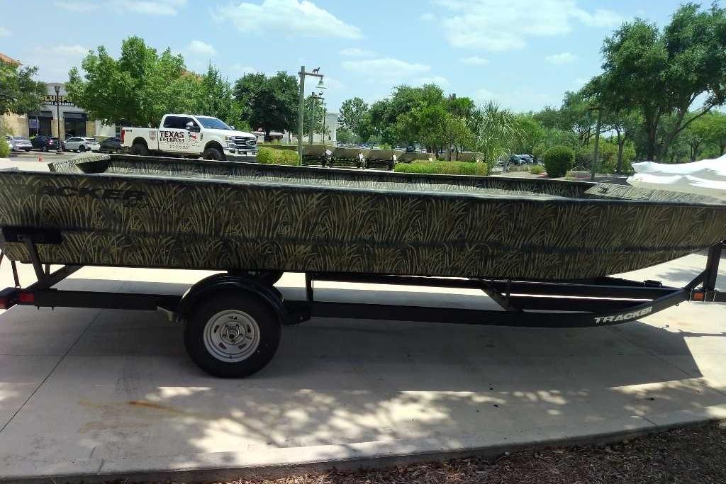 2025 Tracker Grizzly 2072 Utility boat on trailer, parked outdoors.