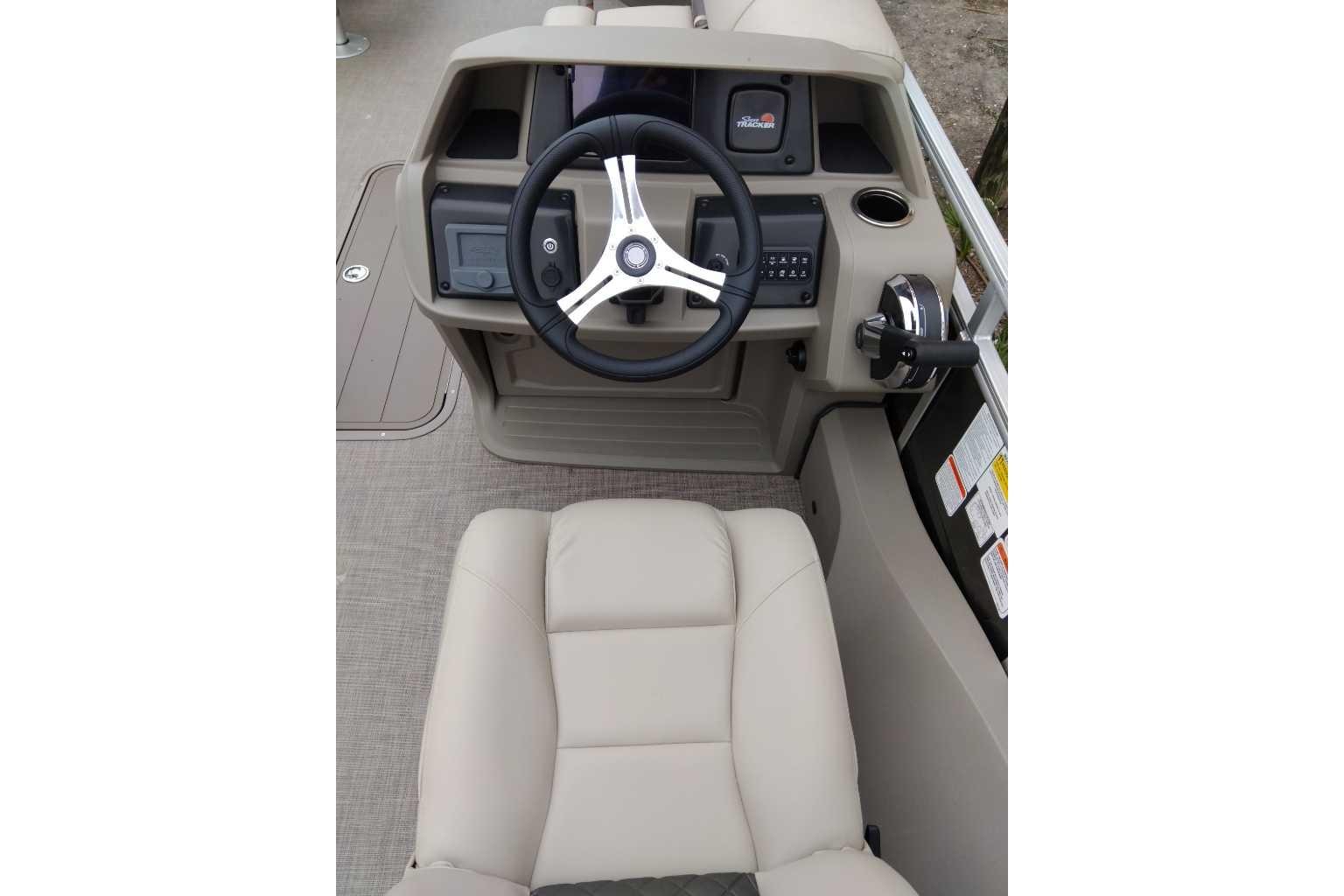 2025 Sun Tracker Fishin' Barge 22 XP3 helm with steering wheel and controls.