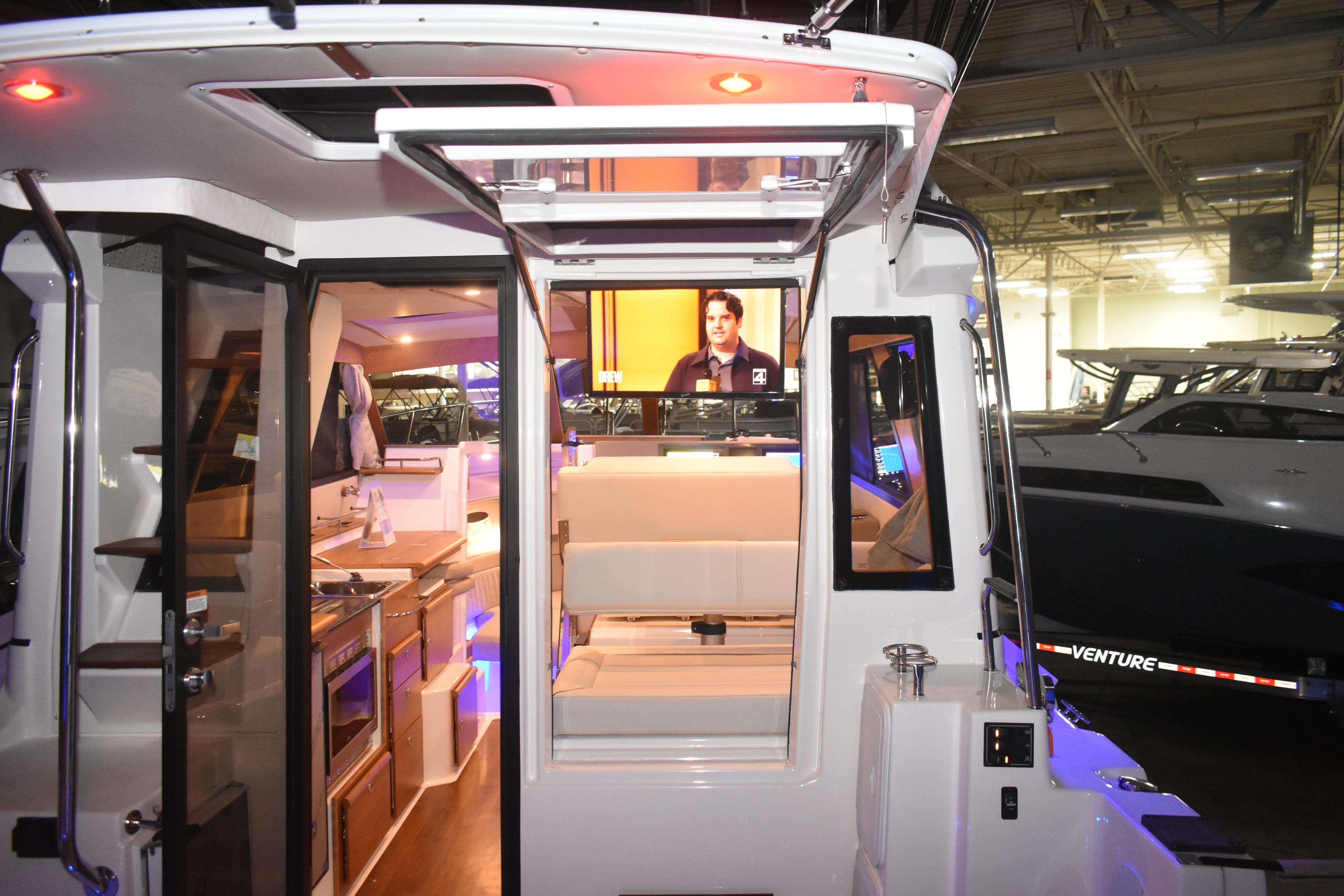 Interior view of 2026 Cutwater C-32 CB boat showcasing modern kitchen and seating area.