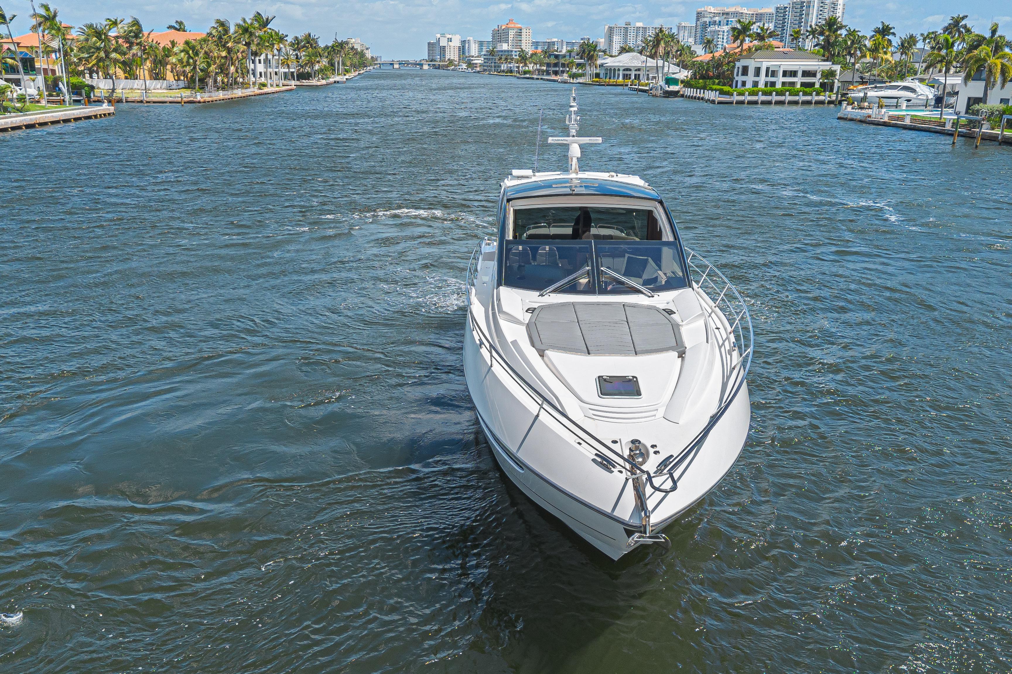 2021 Sunseeker Predator 60 EVO yacht cruising in a scenic waterway.