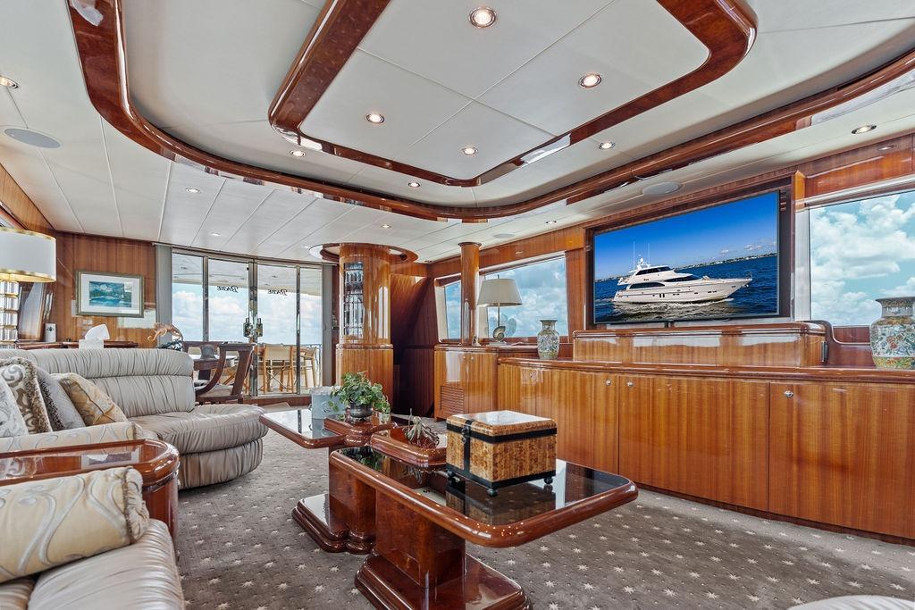 Luxurious interior of 2005 Horizon 82 yacht with elegant wood finishes and plush seating.