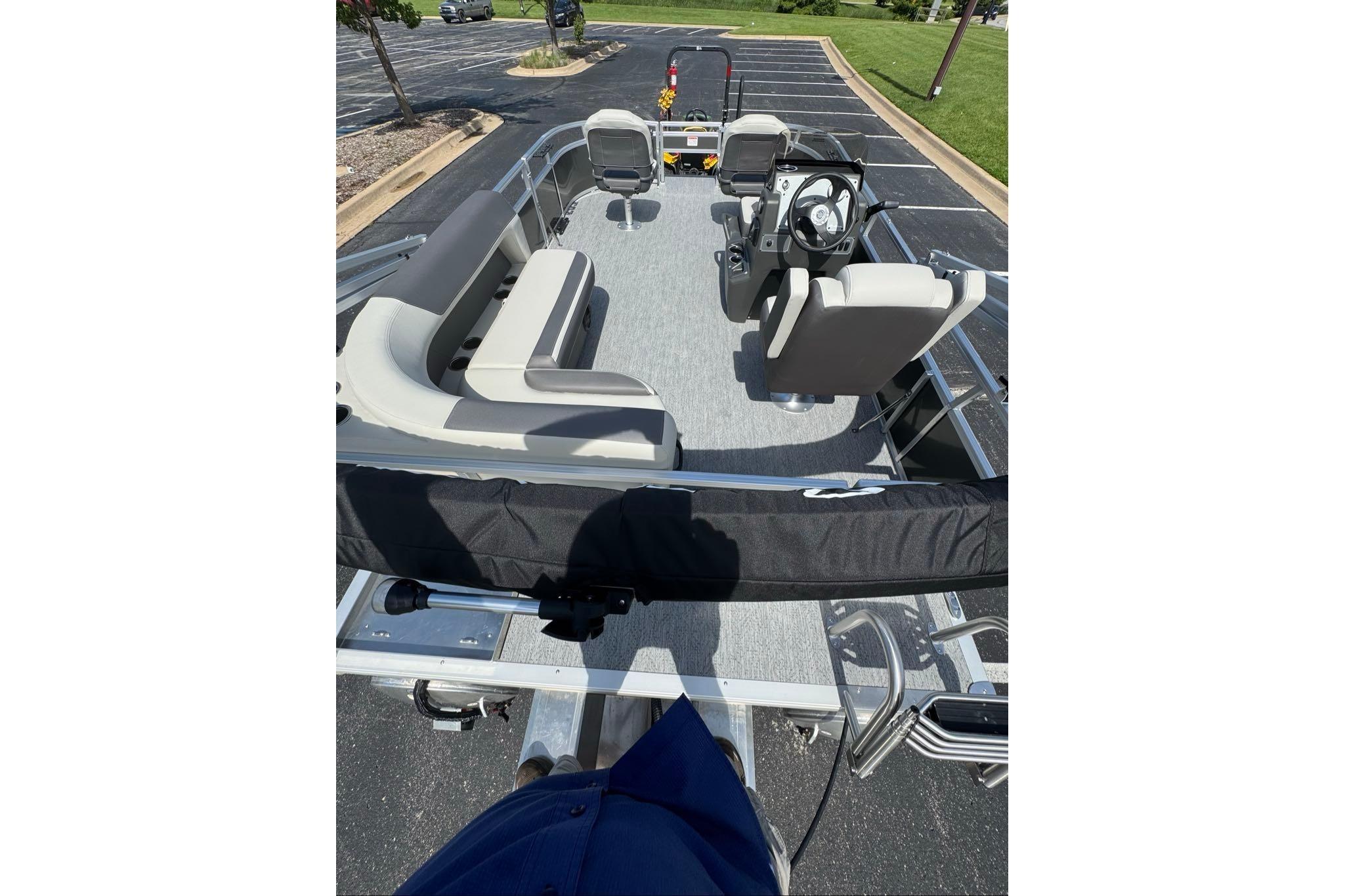 2026 Sun Tracker Bass Buggy 16 XL Select pontoon boat interior with seating and steering console.