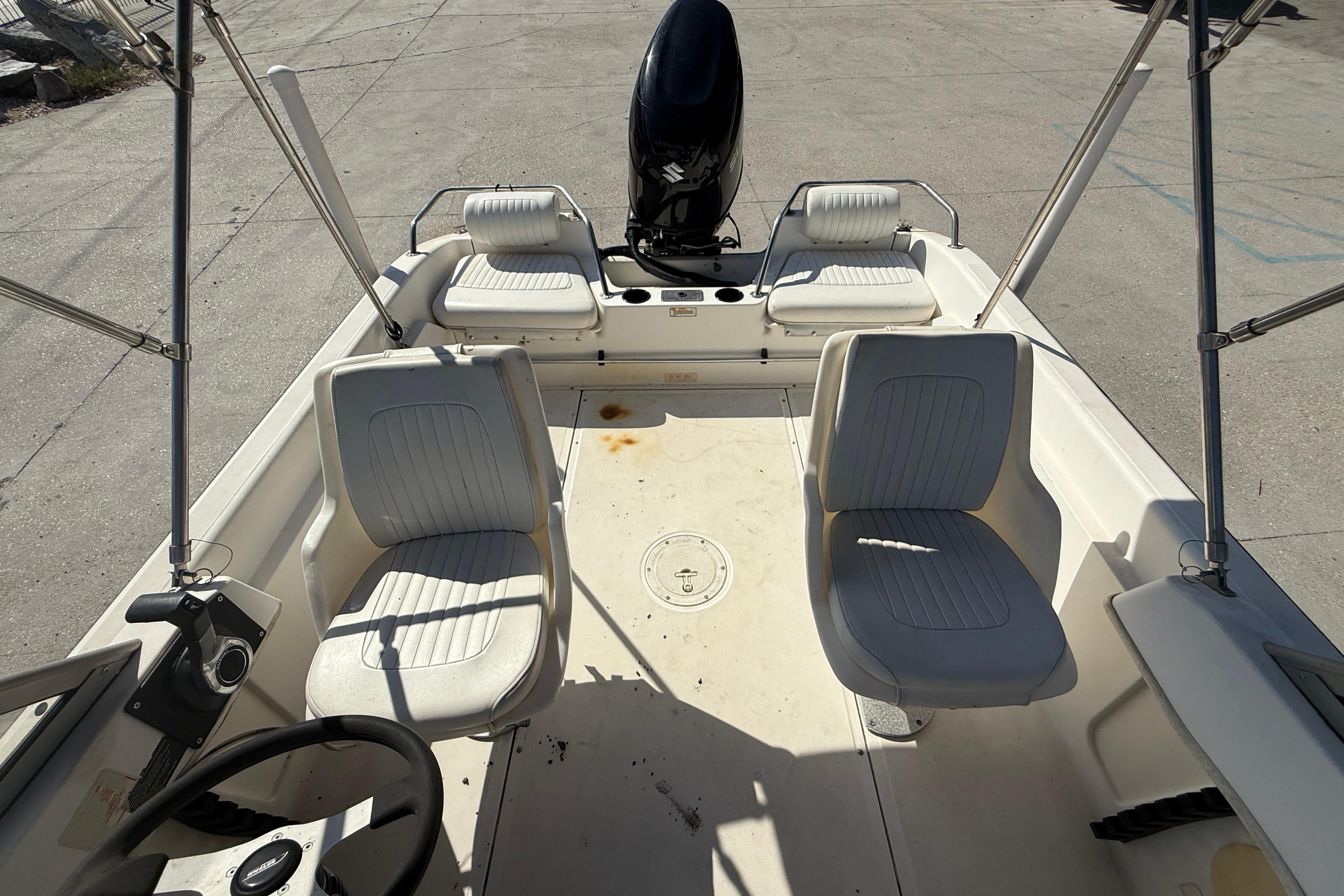 2002 Boston Whaler Ventura 160 boat interior with seating and steering wheel.