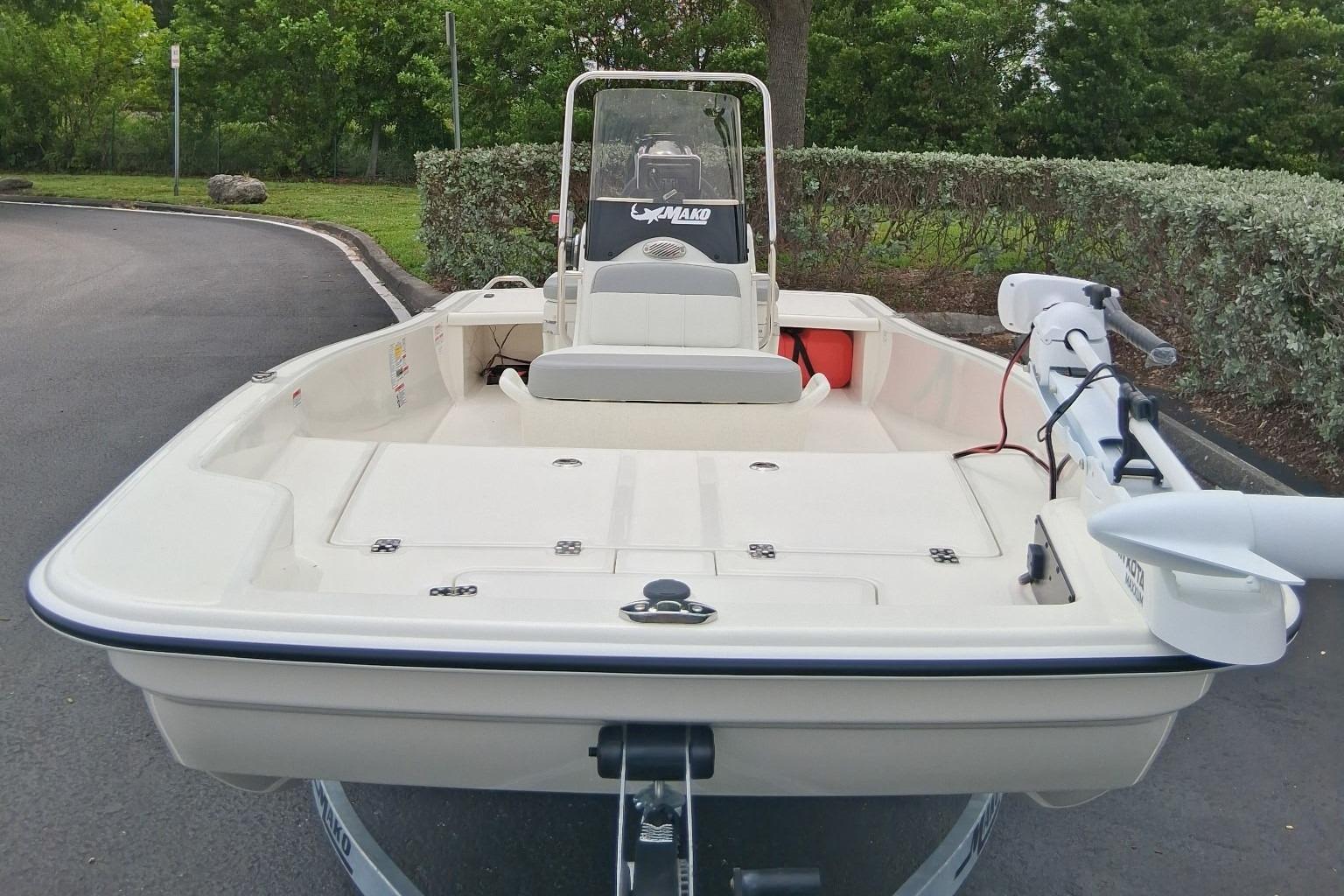 2026 Mako Pro Skiff 15 CC boat, parked on a trailer, with trolling motor attached.