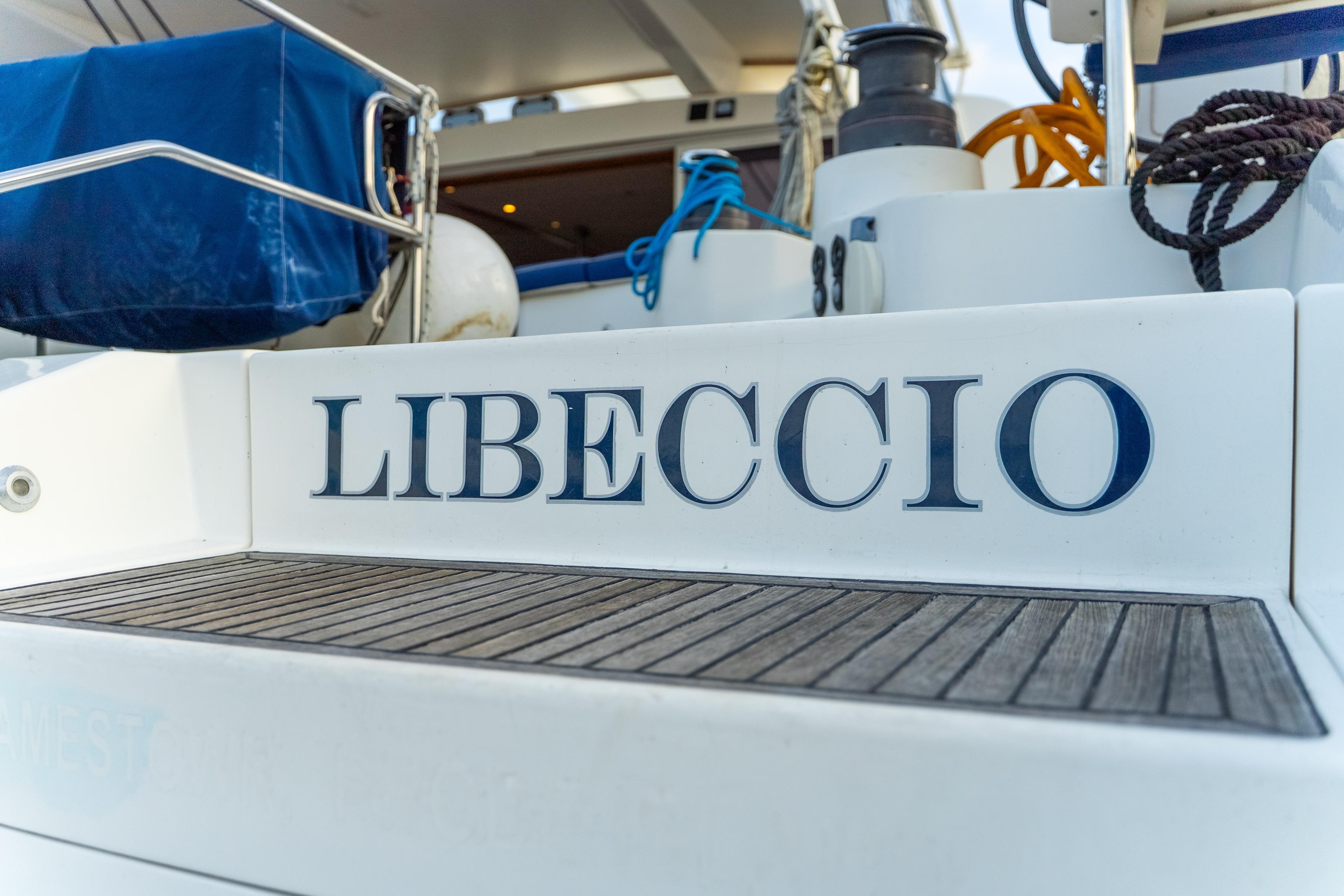 Catana 65 yacht "LIBECCIO" stern view, featuring deck and mooring ropes.