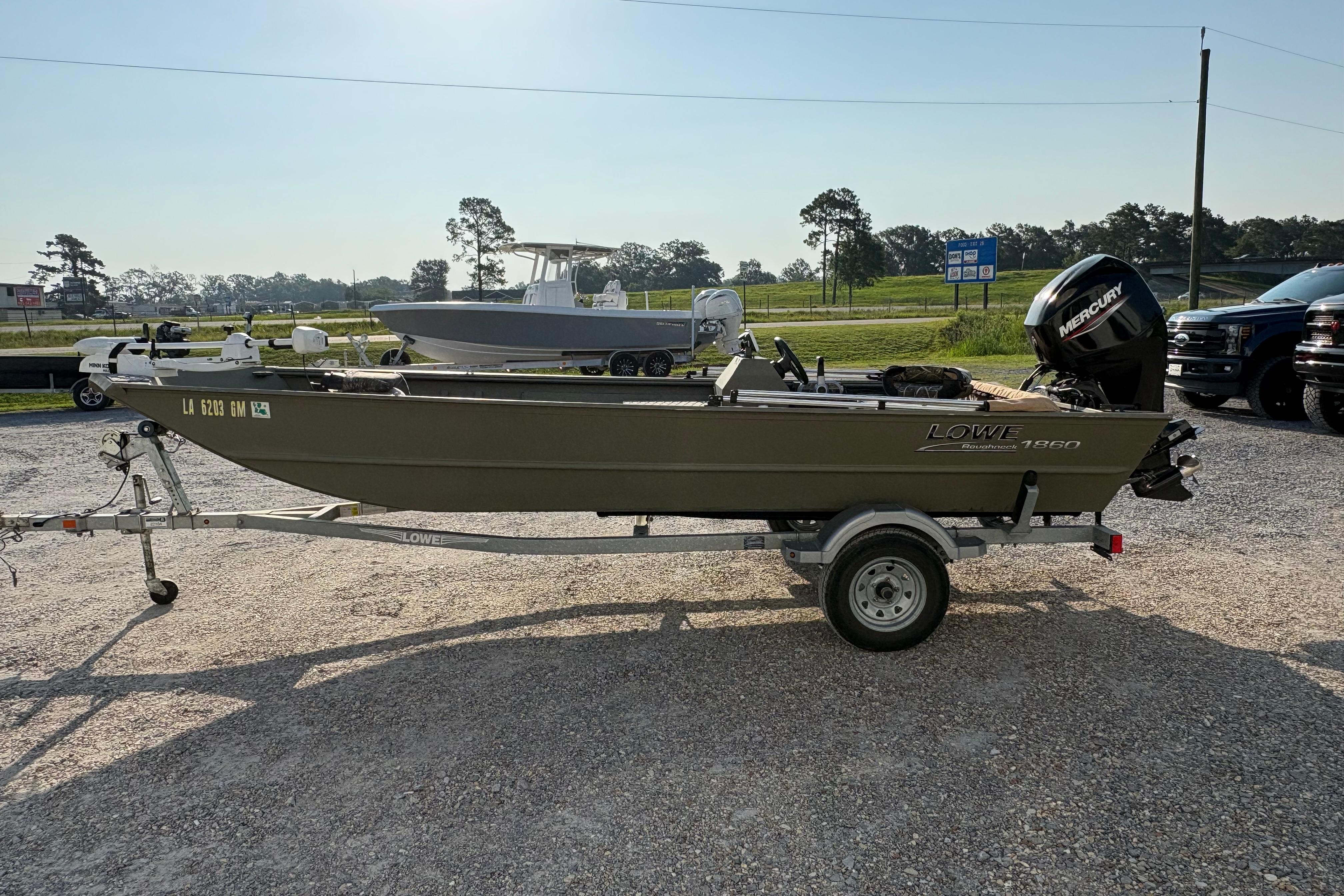 2019 Lowe Roughneck 1860SC boat on trailer, parked outdoors.