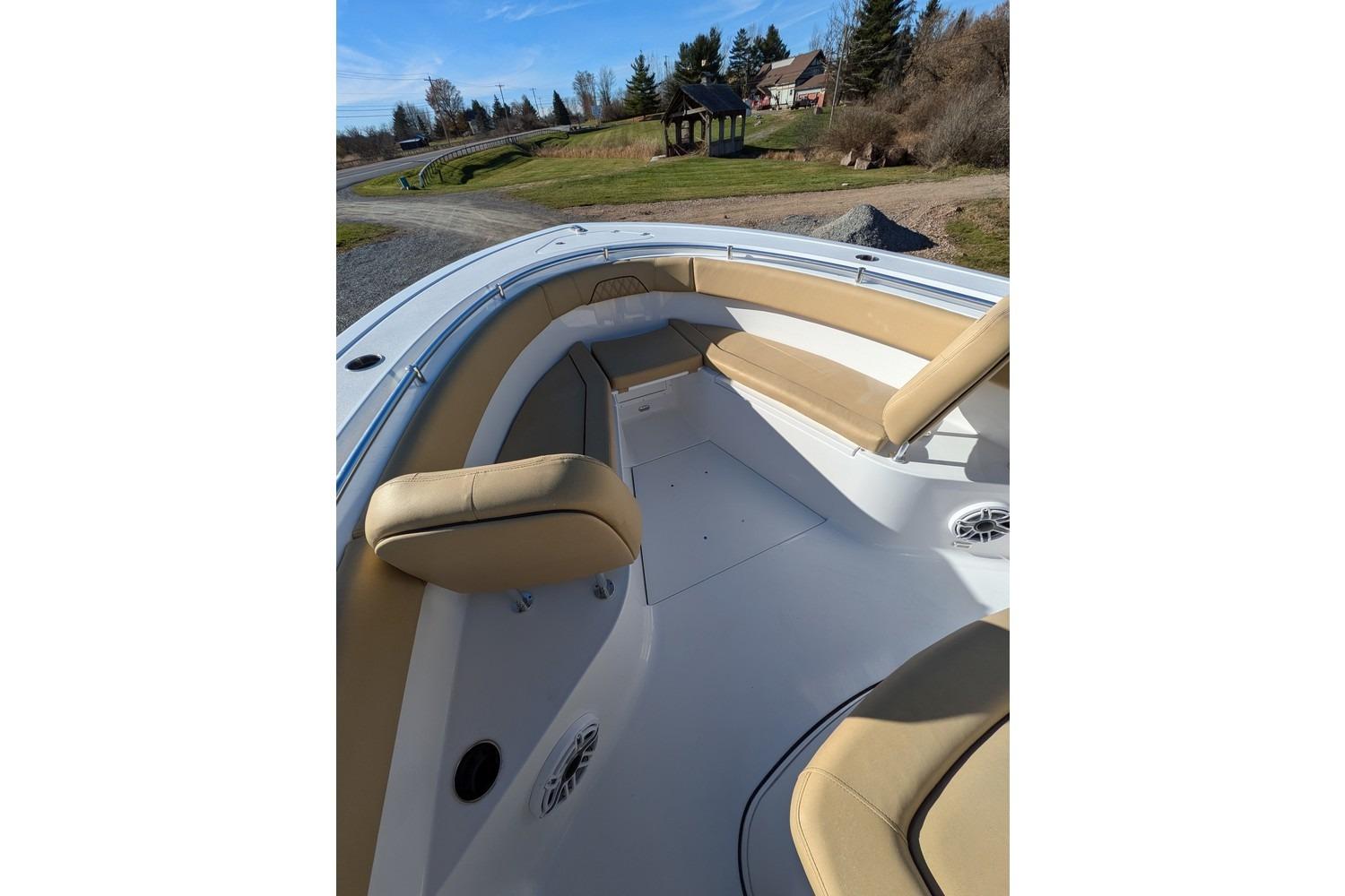2025 Sportsman Open 282 Center Console boat interior with tan seating and speakers.