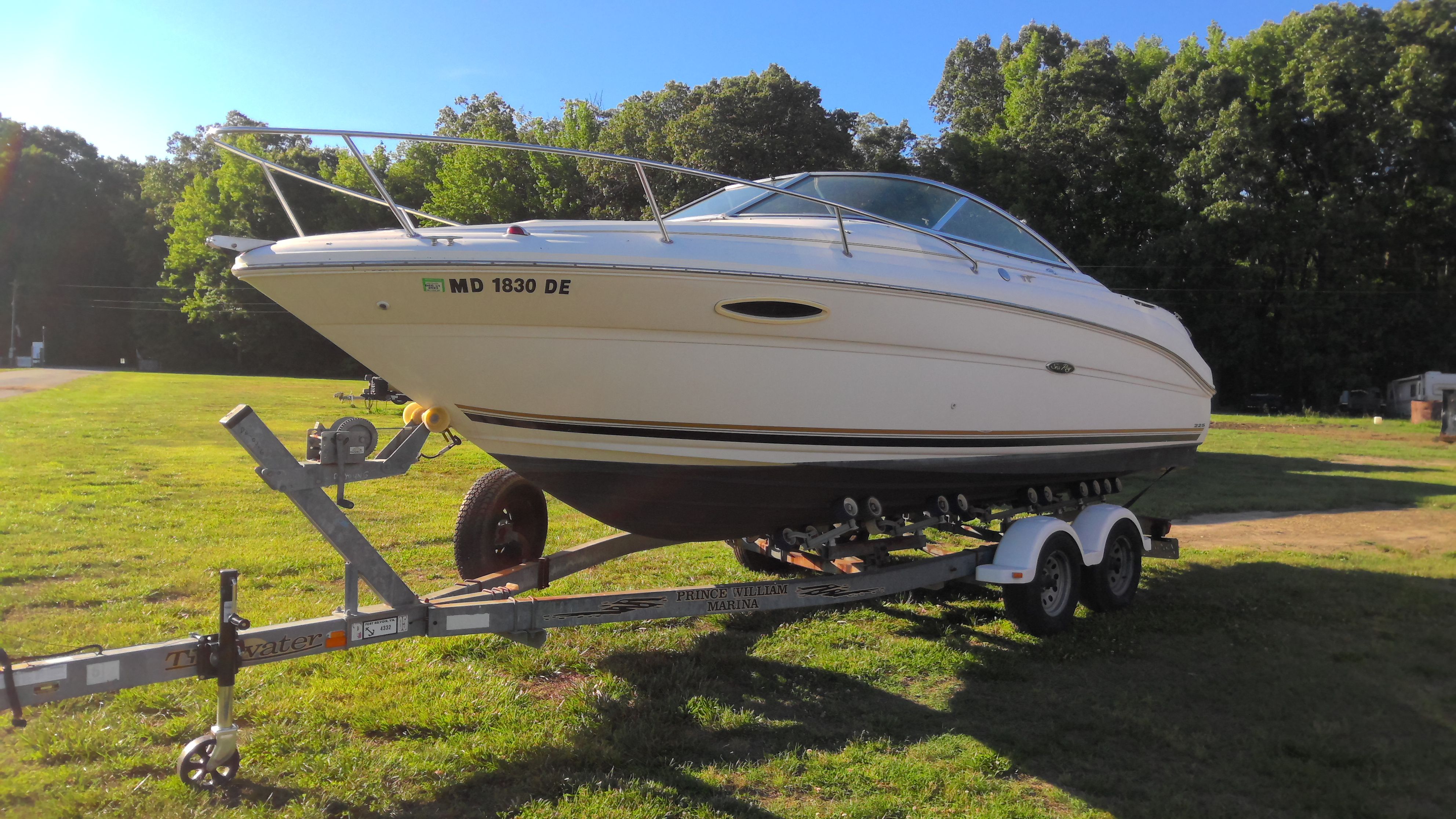 2004 Sea Ray 225 Weekender on trailer outdoors.
