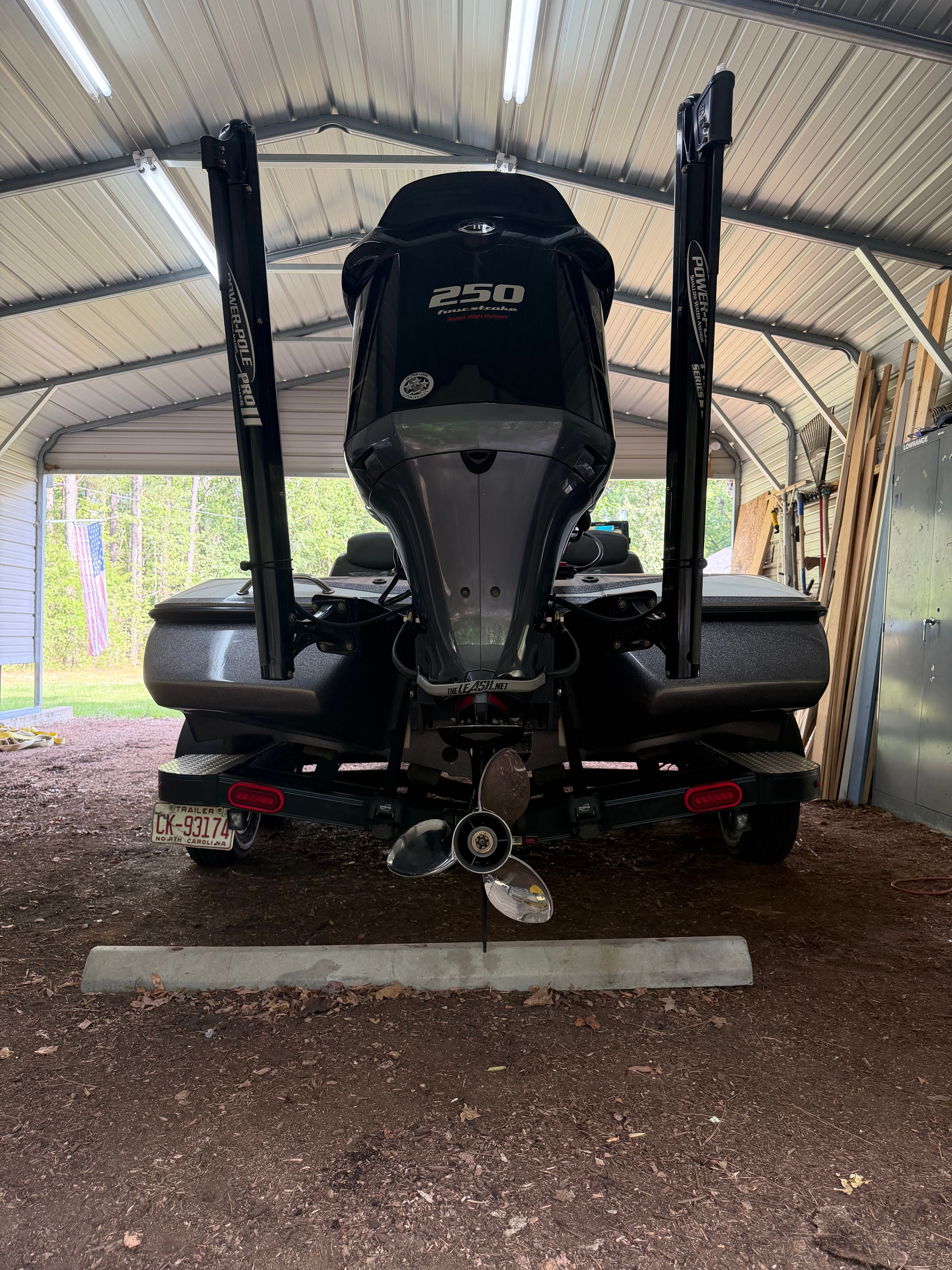 A 2017 Skeeter ZX250 boat is parked in a covered area on a gravel surface.