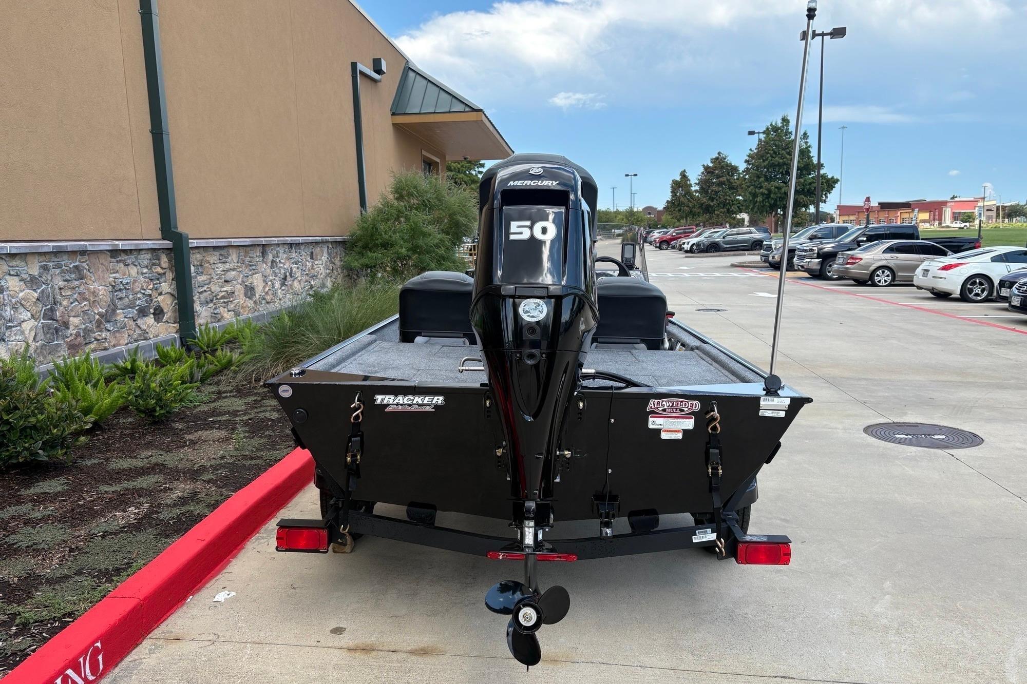 2026 Tracker Bass Tracker Classic XL boat with Mercury 50 engine in parking lot.
