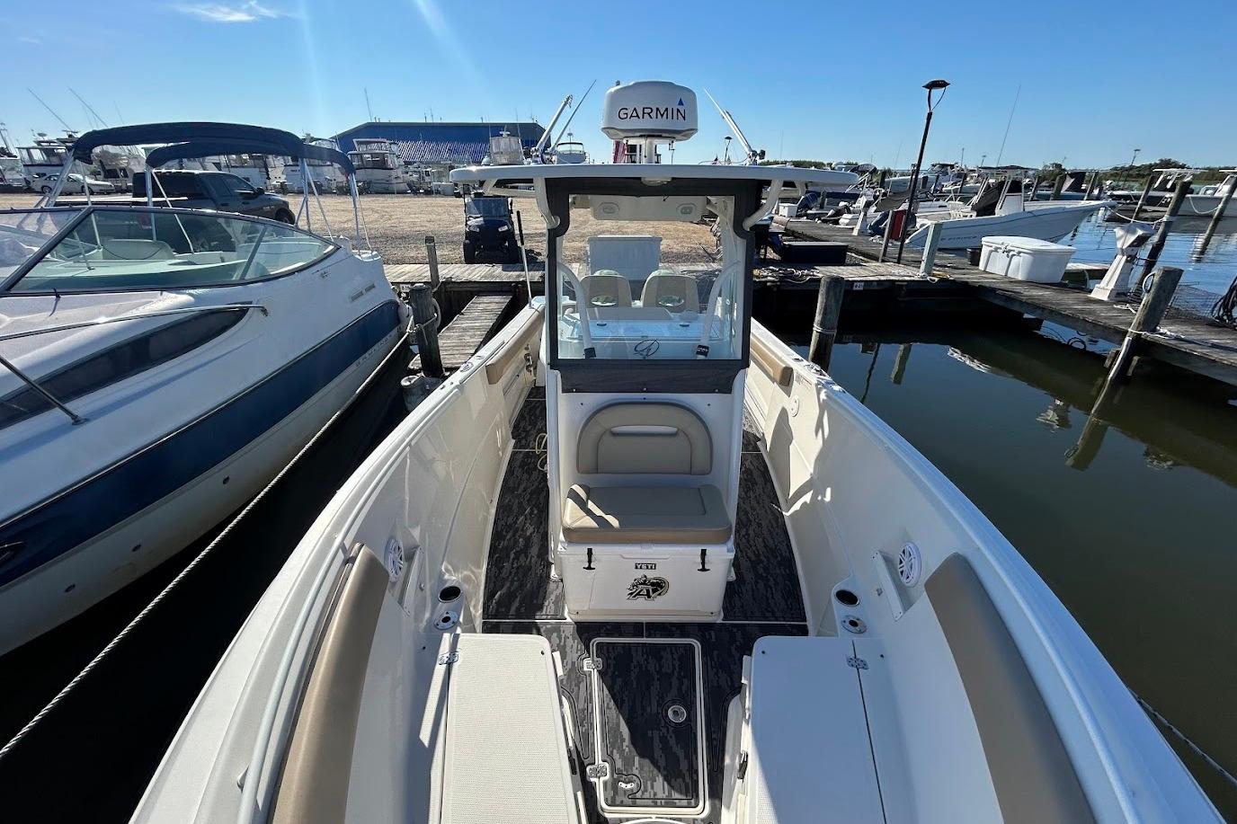 2019 Sailfish 270 CC boat docked at marina, featuring Garmin equipment.