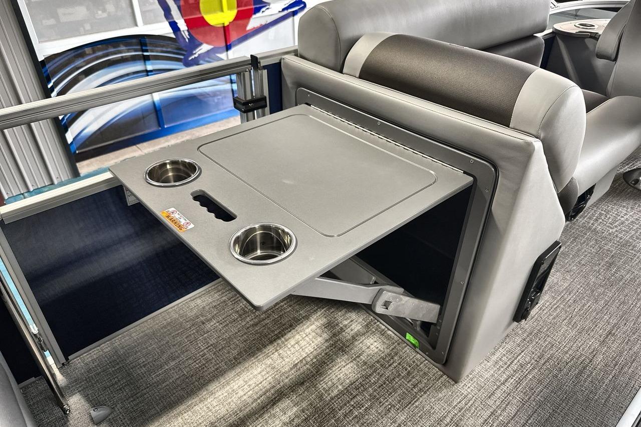 2026 Landau Island Breeze 23F boat interior with foldable table and cup holders.