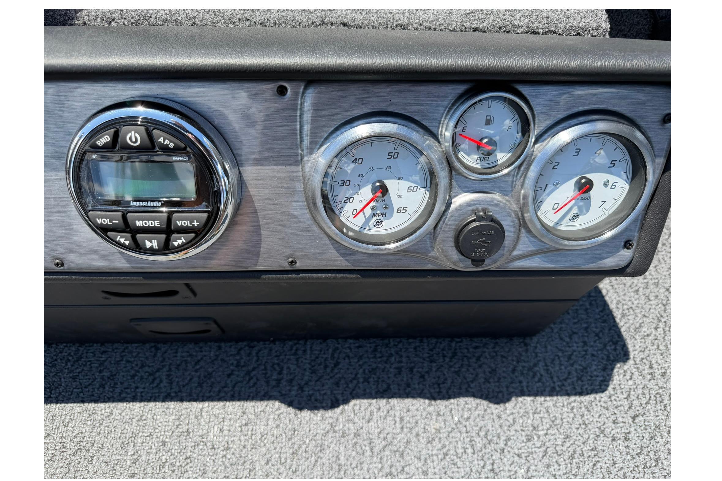 Dashboard of 2027 Lund 1875 Pro Guide boat with audio controls and gauges.