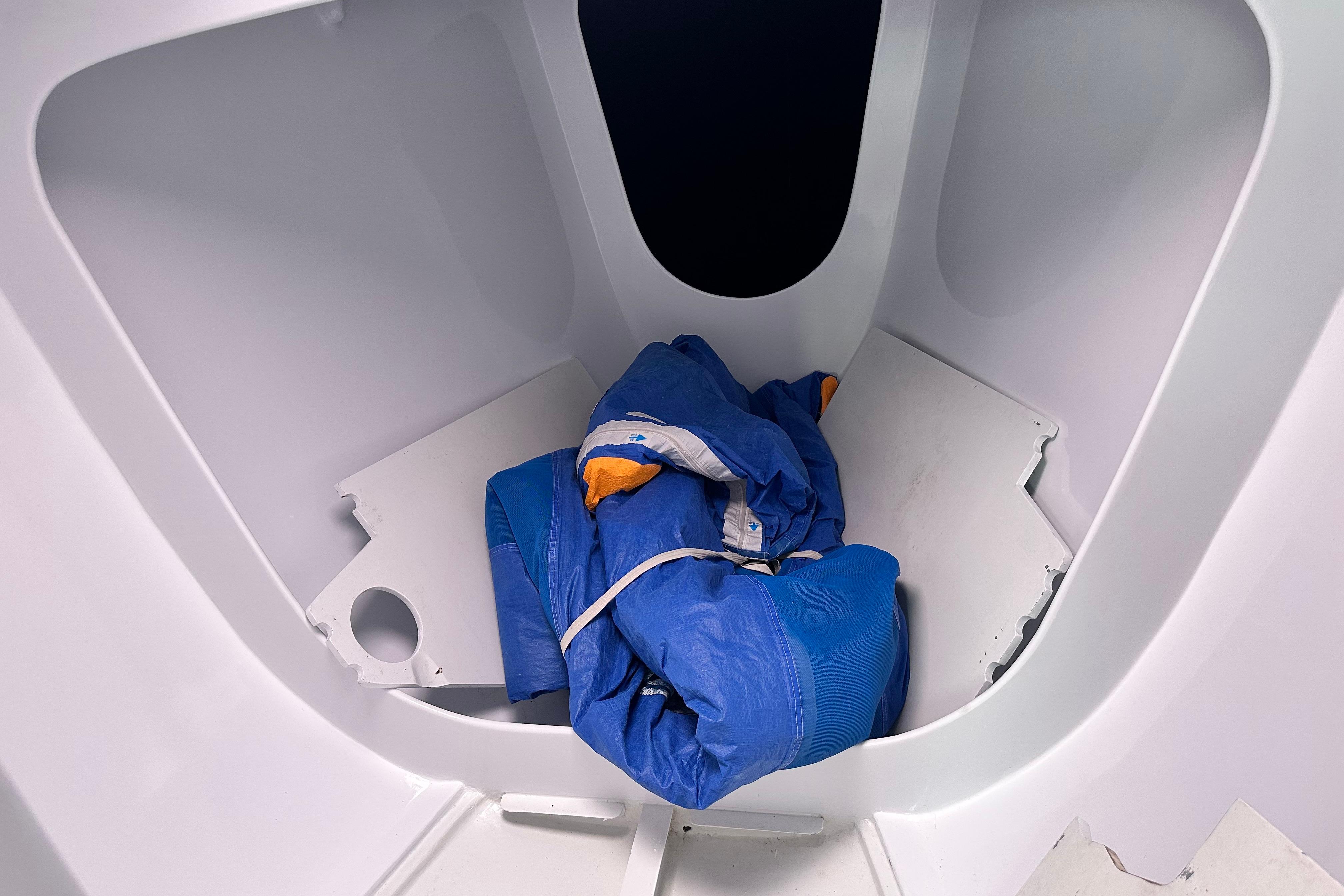 Interior of 1994 Farr 40 ILC sailboat with blue sail stored inside.