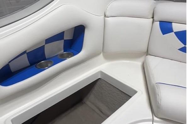 Interior of a 1999 Tide Craft Trophy Angler boat with white and blue seating.