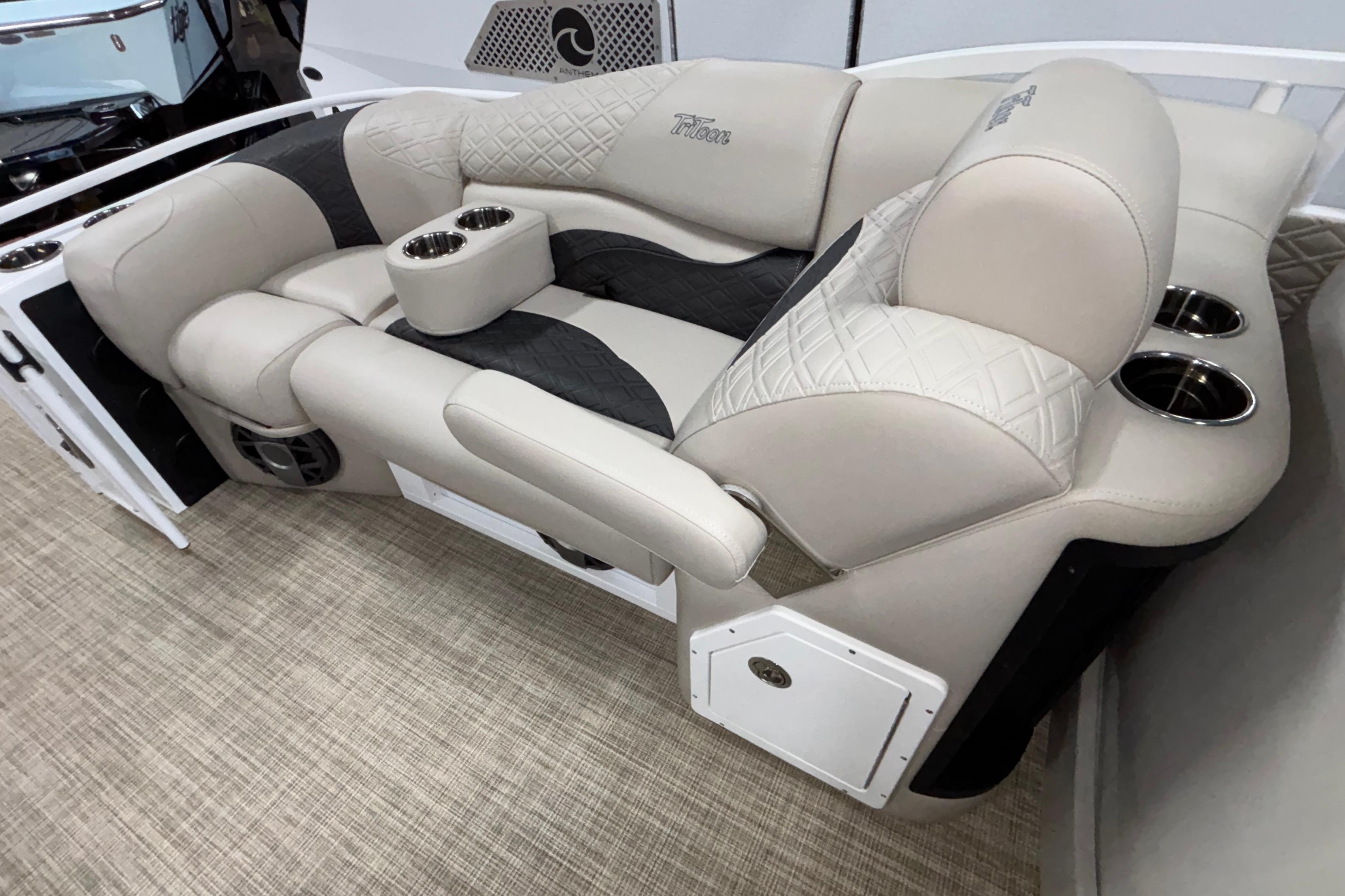Luxurious seating on 2026 JC Sporttoon 26TT boat with cup holders and quilted upholstery.