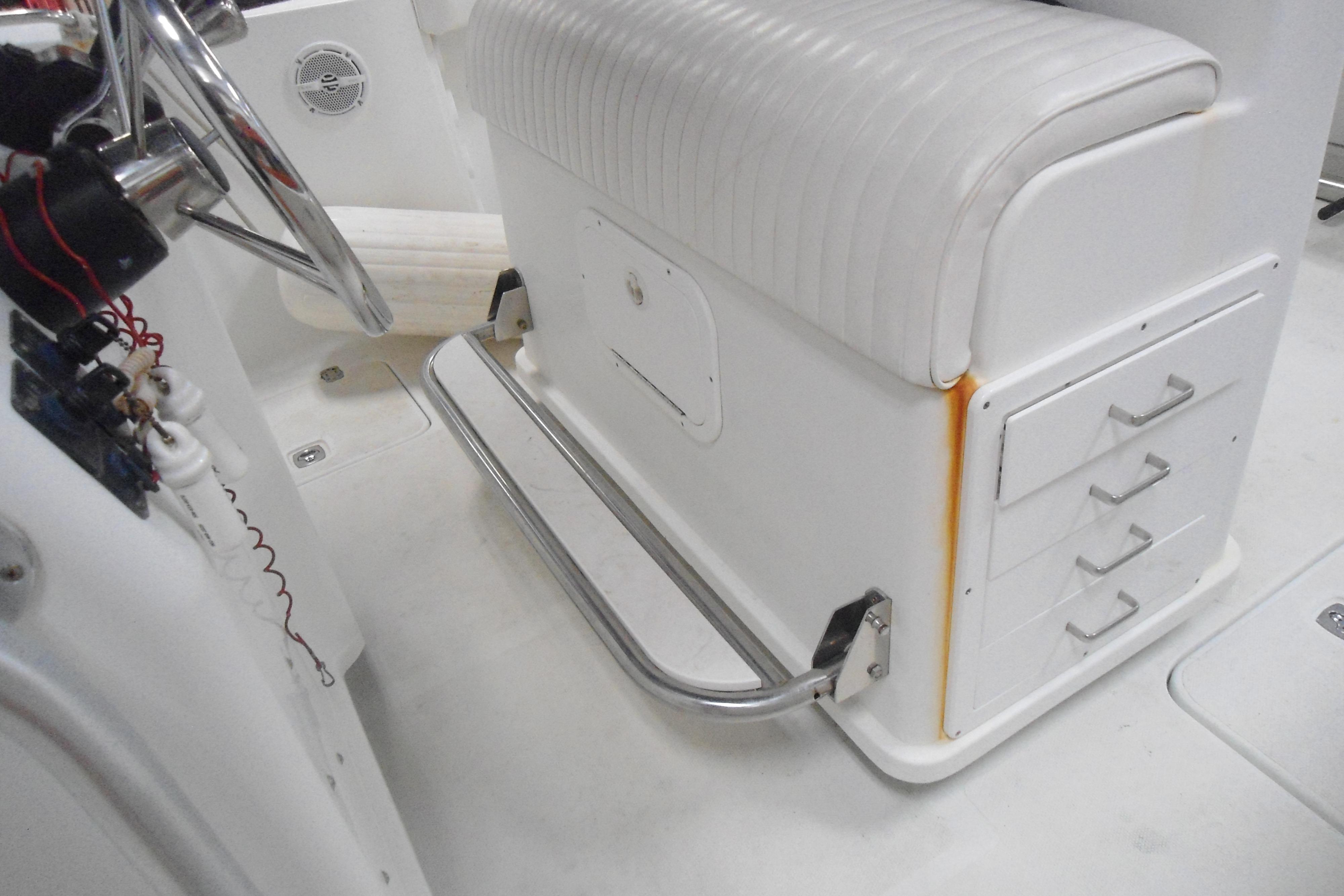 2004 Polar 2700 Center Console boat interior with steering wheel and storage drawers.