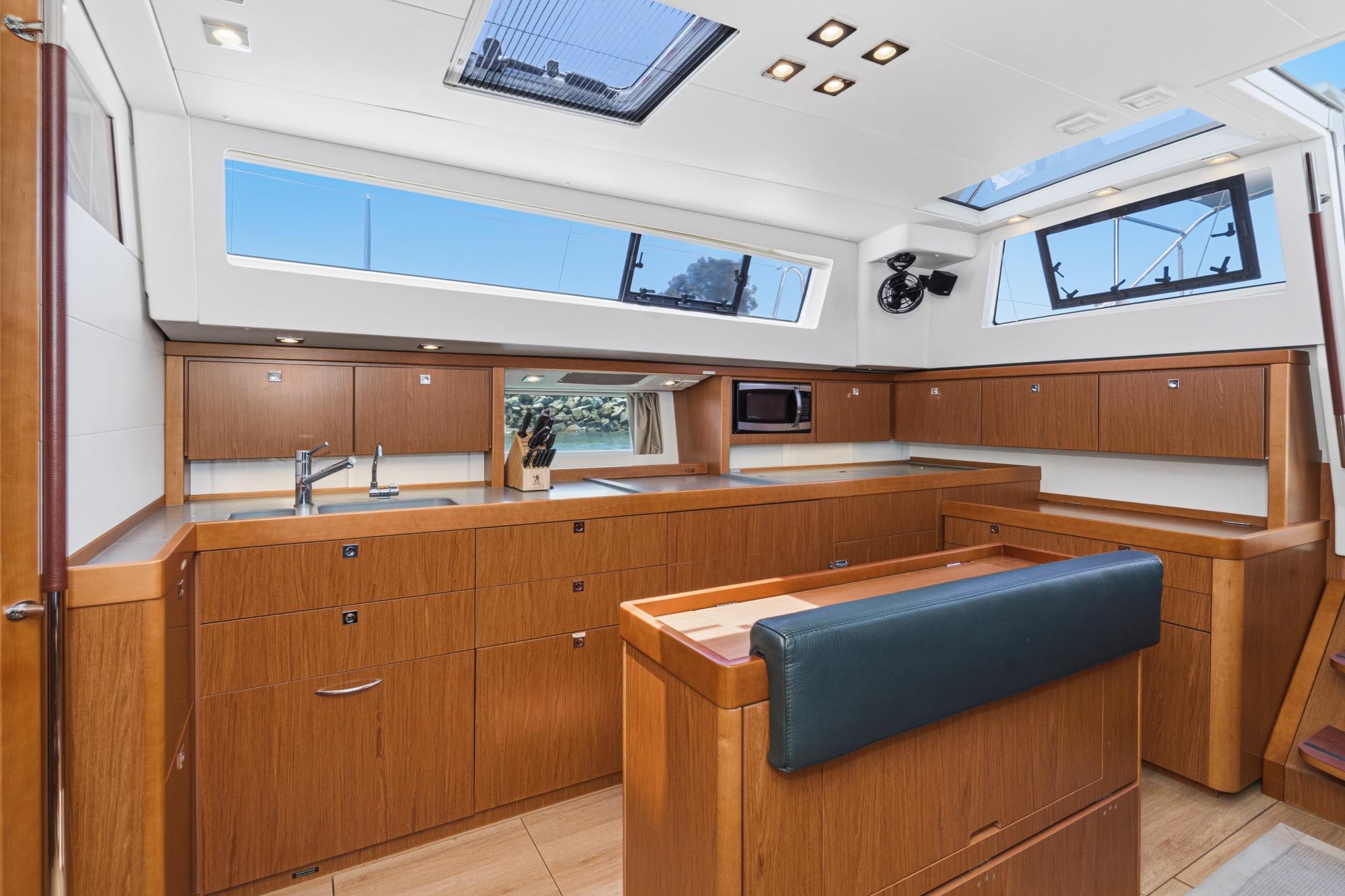 Luxurious interior of 2017 Beneteau Sense 50 yacht with modern kitchen and ample natural light.