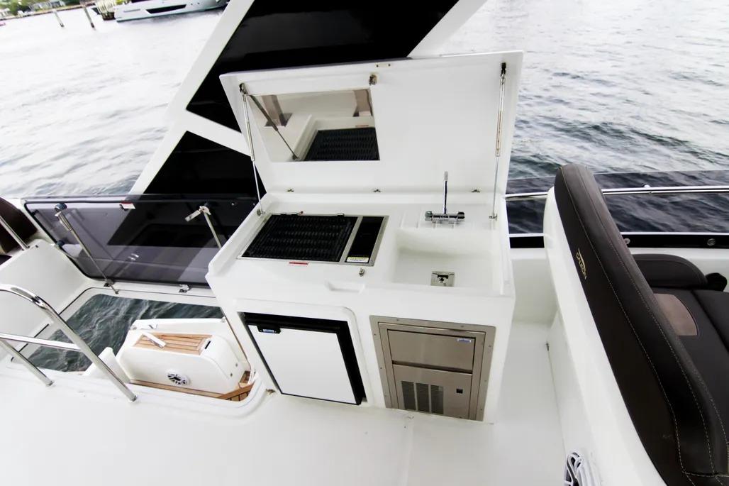 Outdoor kitchen on 2020 Galeon 550 Fly yacht with grill and sink by the water.