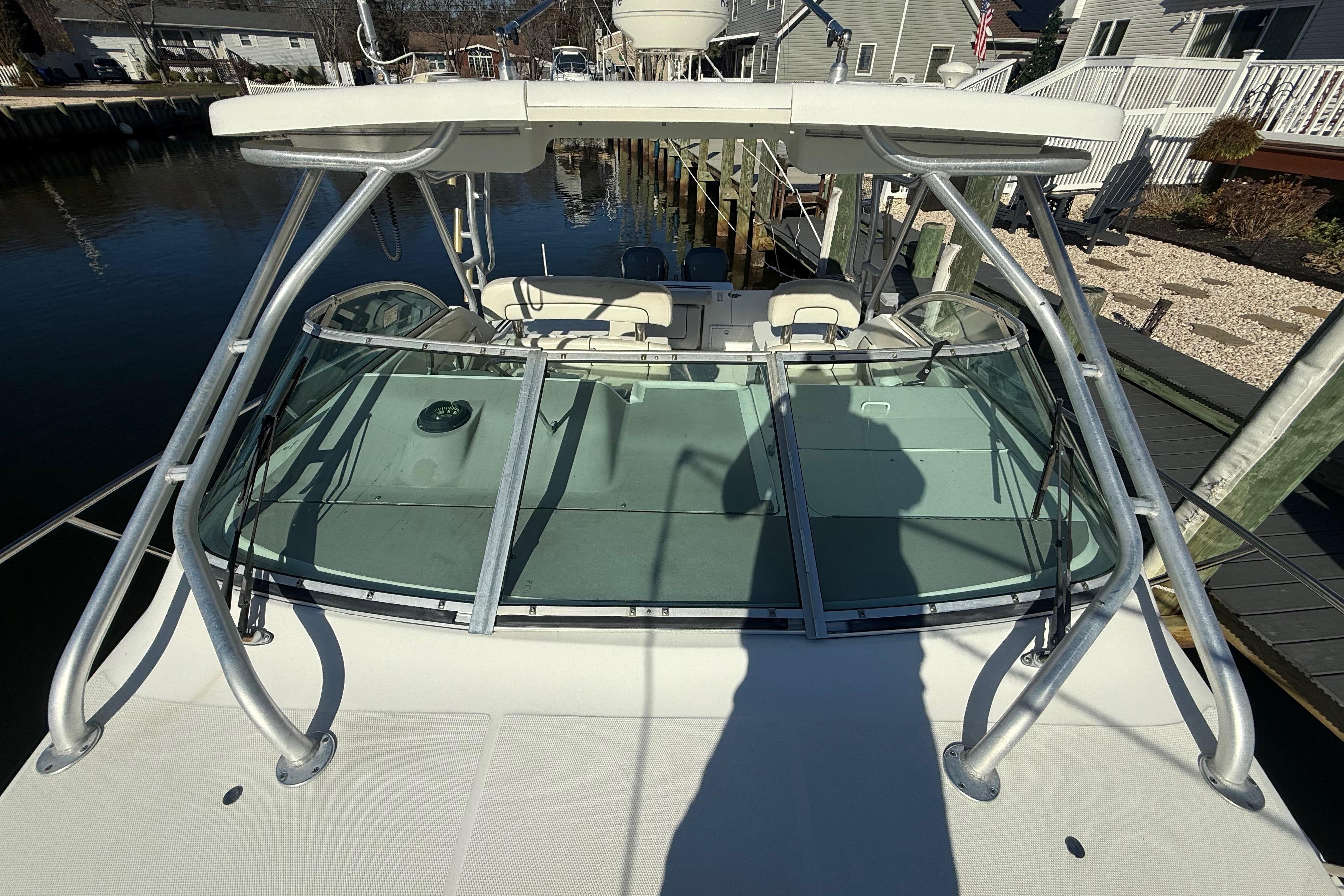 2002 Wellcraft 290 Coastal boat docked, featuring a sturdy frame and spacious deck.