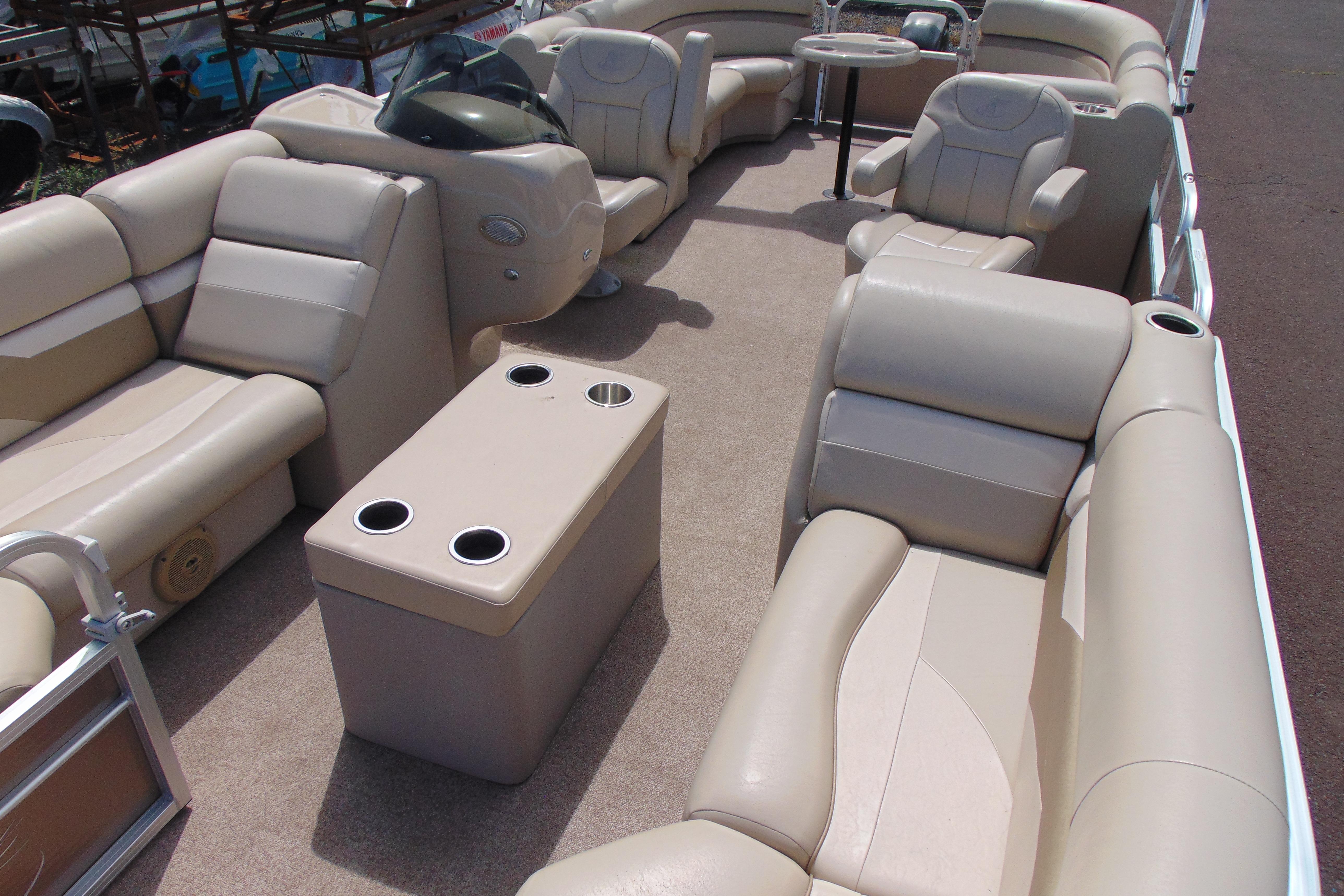 2016 Misty Harbor 245 Adventure CU pontoon boat interior with beige seating and cup holders.
