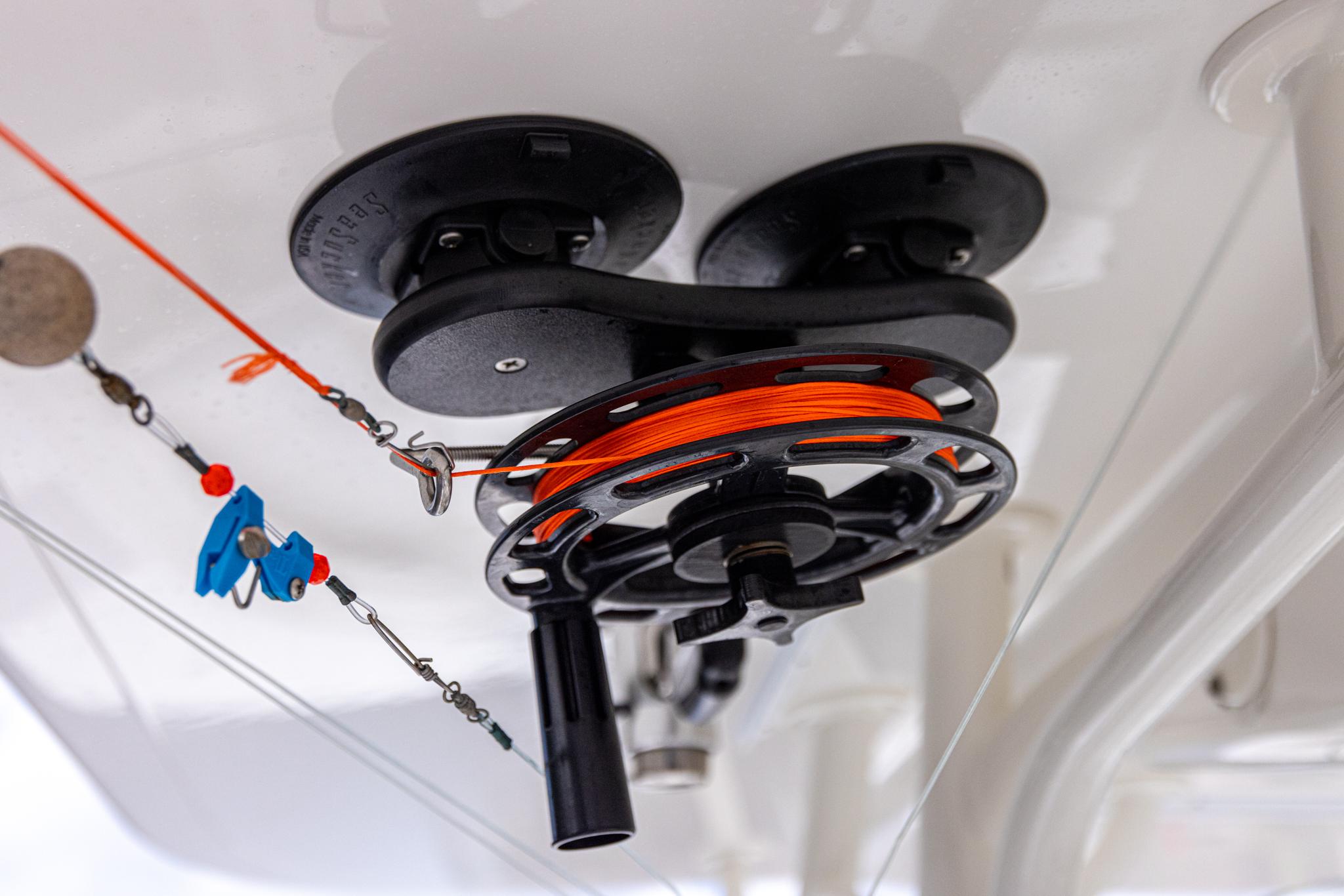 Fishing reel setup on 2019 Regulator 34 boat, featuring orange line and tackle.