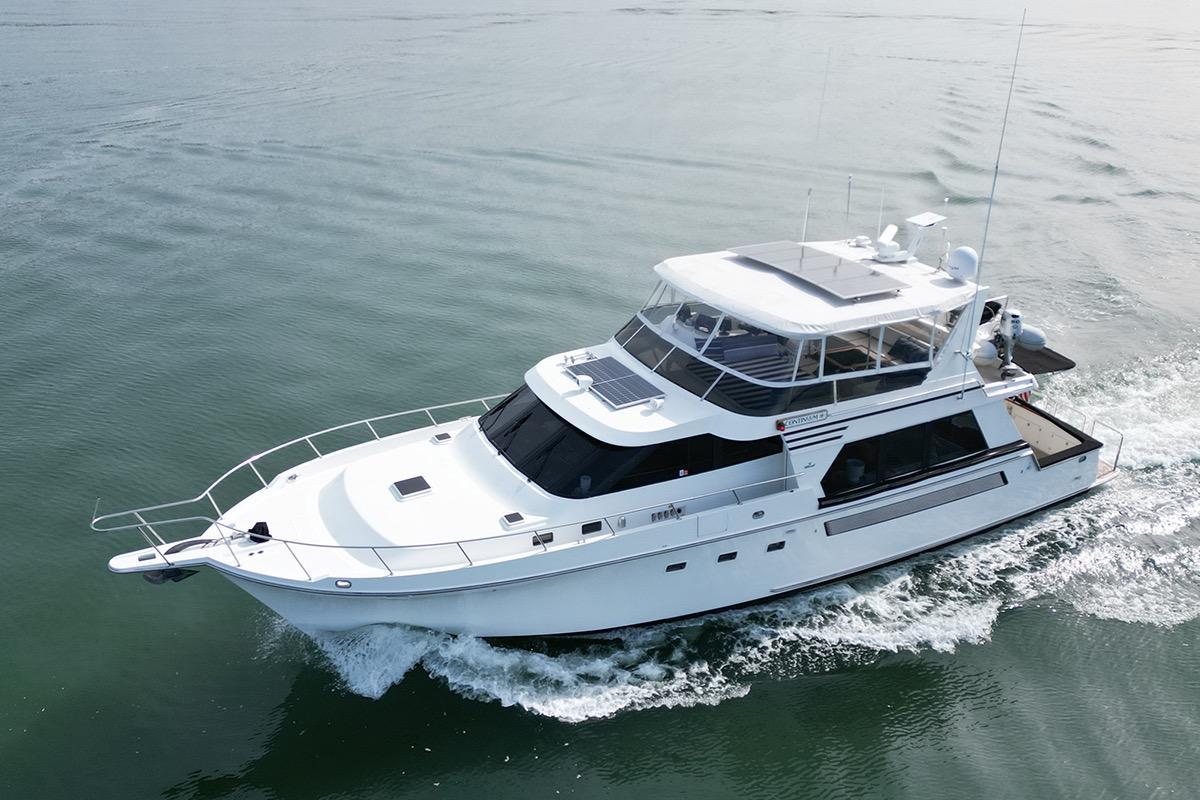 1991 Tollycraft 57 Pilothouse Motor Yacht cruising on calm waters.