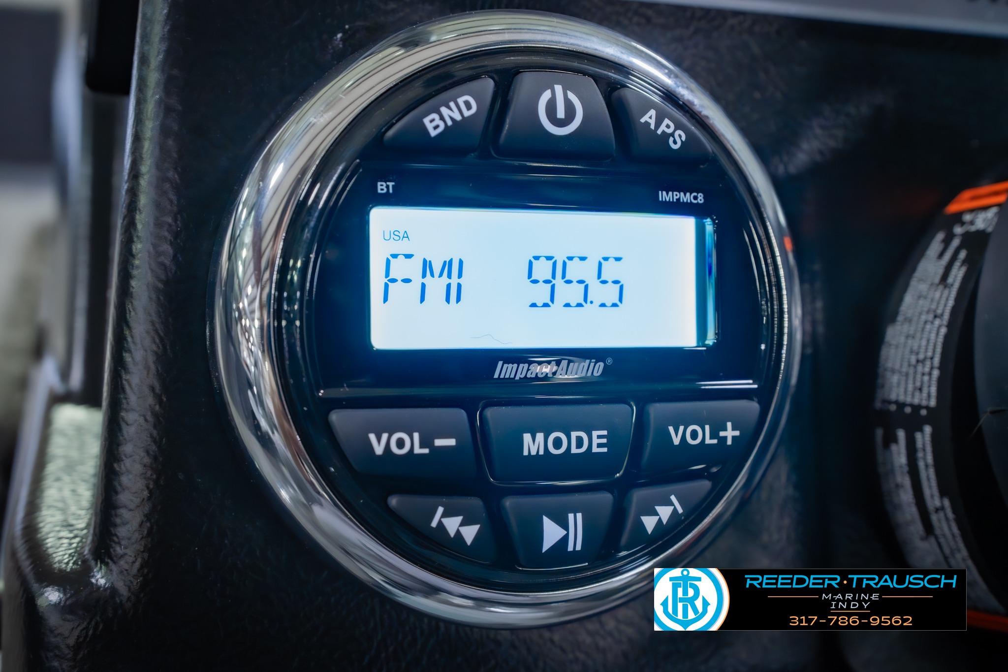 Close-up of a 2026 Lund 1875 Impact XS audio system displaying FM 95.5.