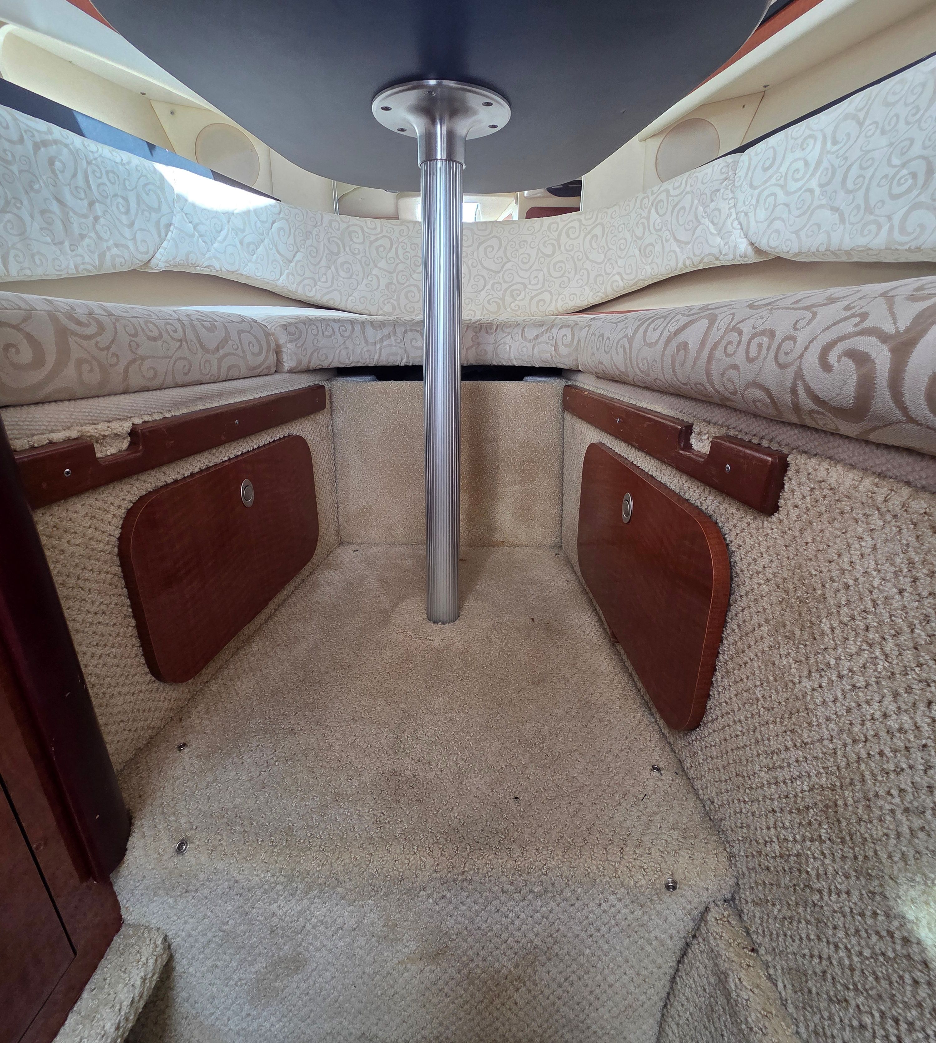 Interior of the 2005 Sea Ray Sundancer 260 with beige upholstery and carpeted floor.