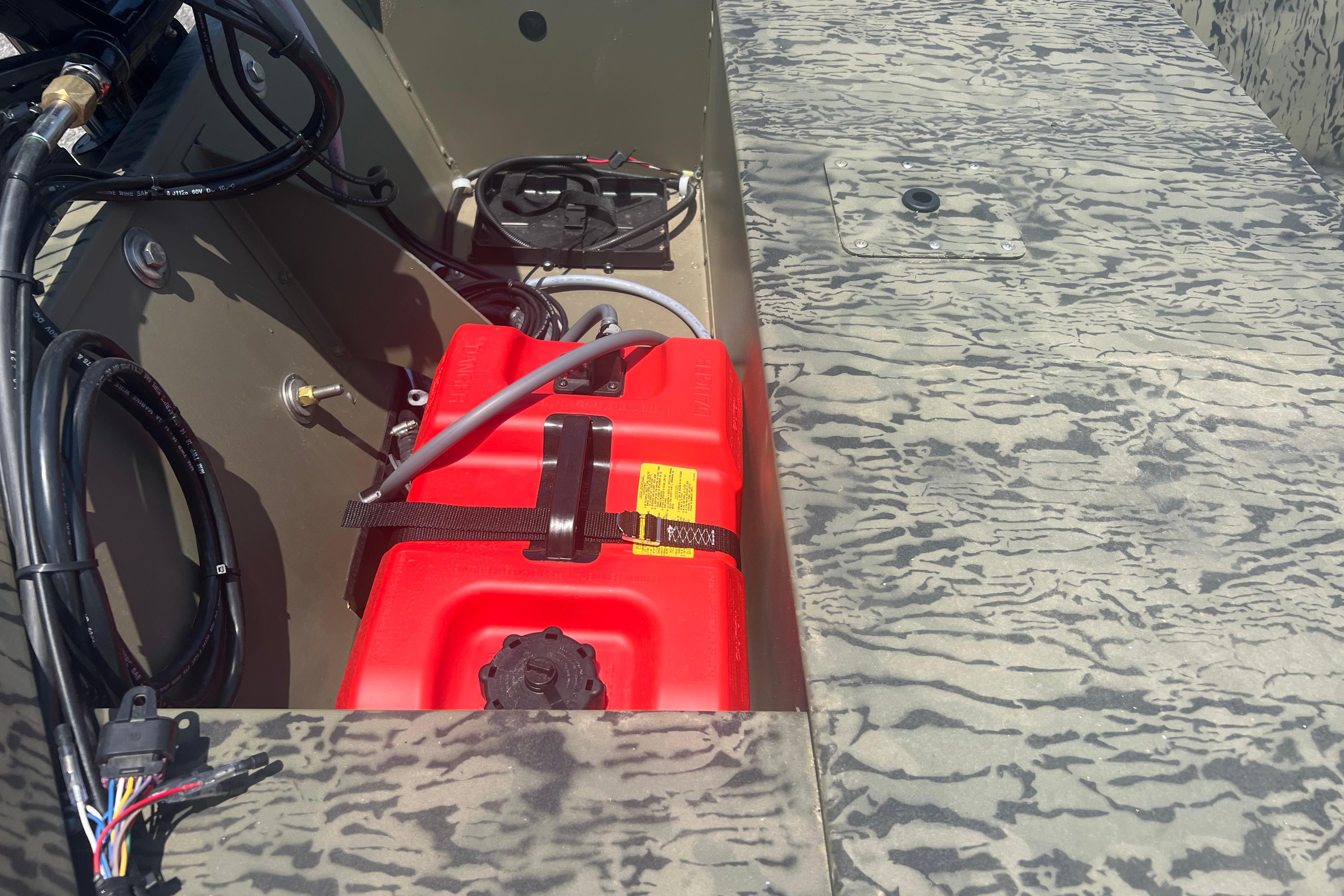 2026 Tracker Grizzly 1648 SC boat interior with red fuel tank and wiring.