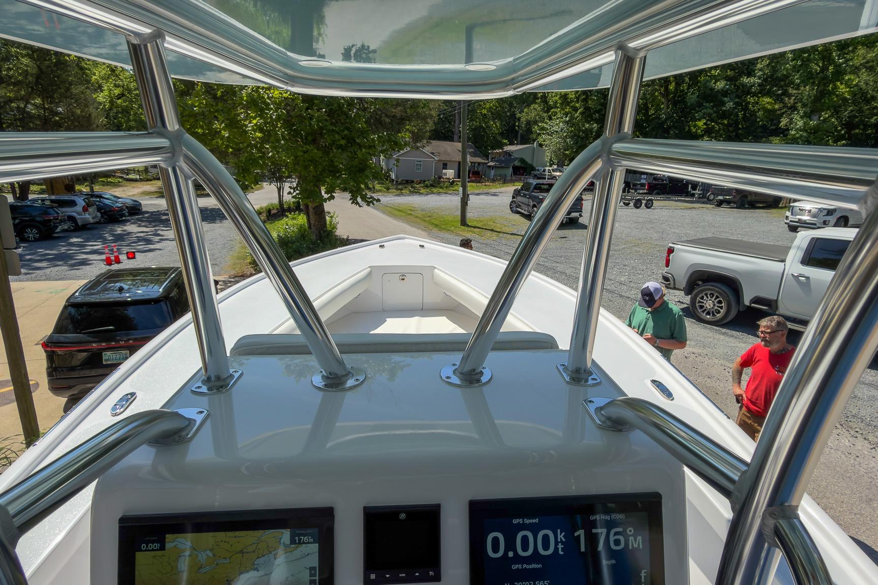 View from Weaver 25 boat cockpit, showcasing navigation screens and parked vehicles, 2025 model.