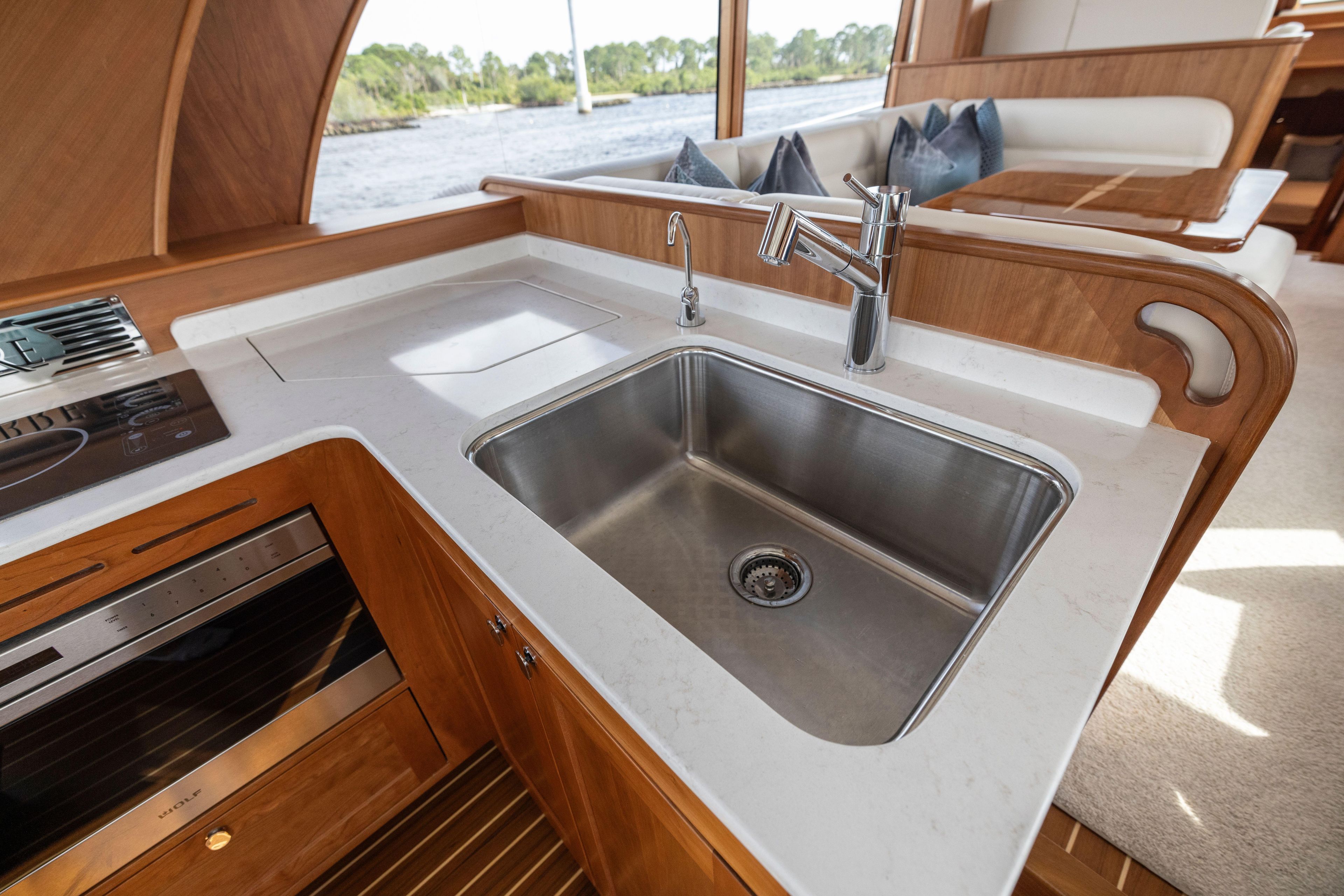 Modern kitchen area in 2026 Sabre 58 Salon Express yacht with stainless steel sink.